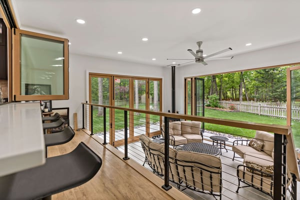 Lower-level living room with large doors opening to backyard
