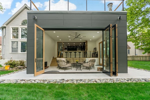 Indoor outdoor modern room addition on back of home