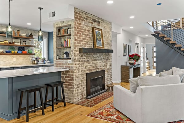 Open concept with brick fireplace in kitchen and living room space