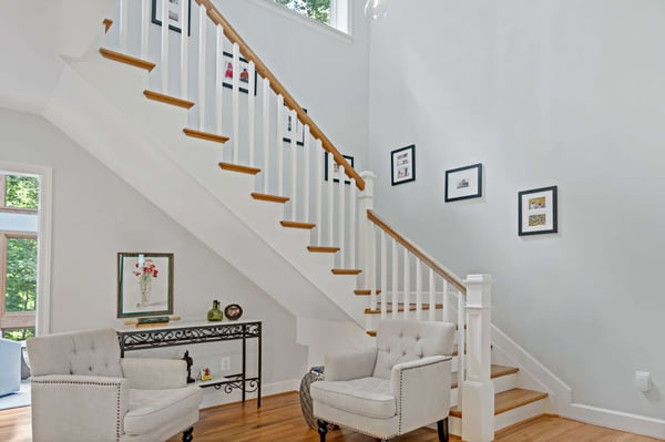 White and brown wood staircase in foyer of home