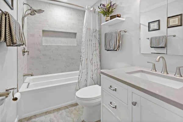 Neutral brown and white bathroom with bathtub shower and curtain