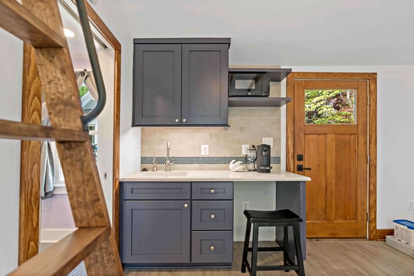 Mini wet bar with dark blue grey cabinets