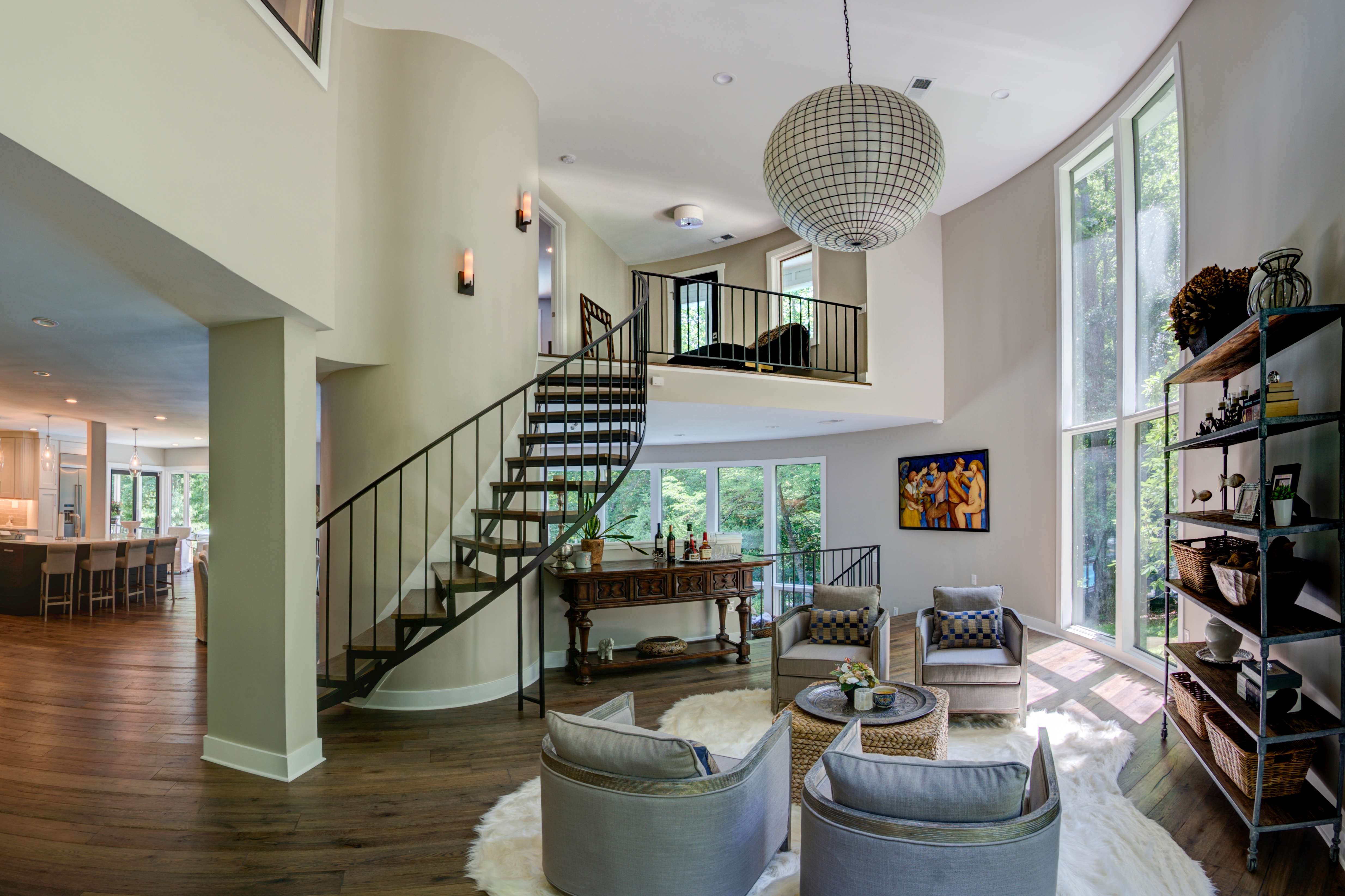 Round living room wall with curved metal stairwell