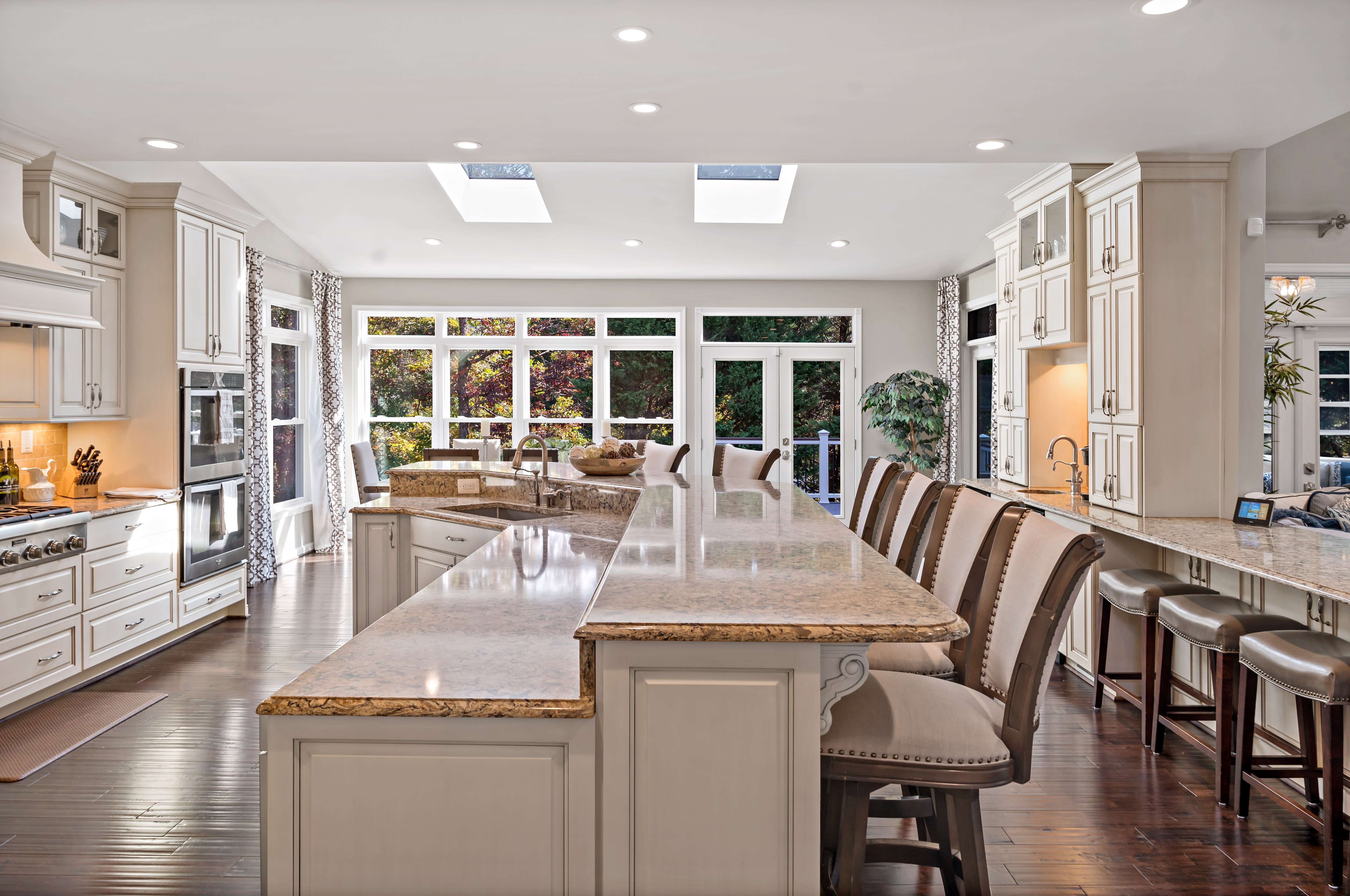 Cream kitchen with long curved island with seating