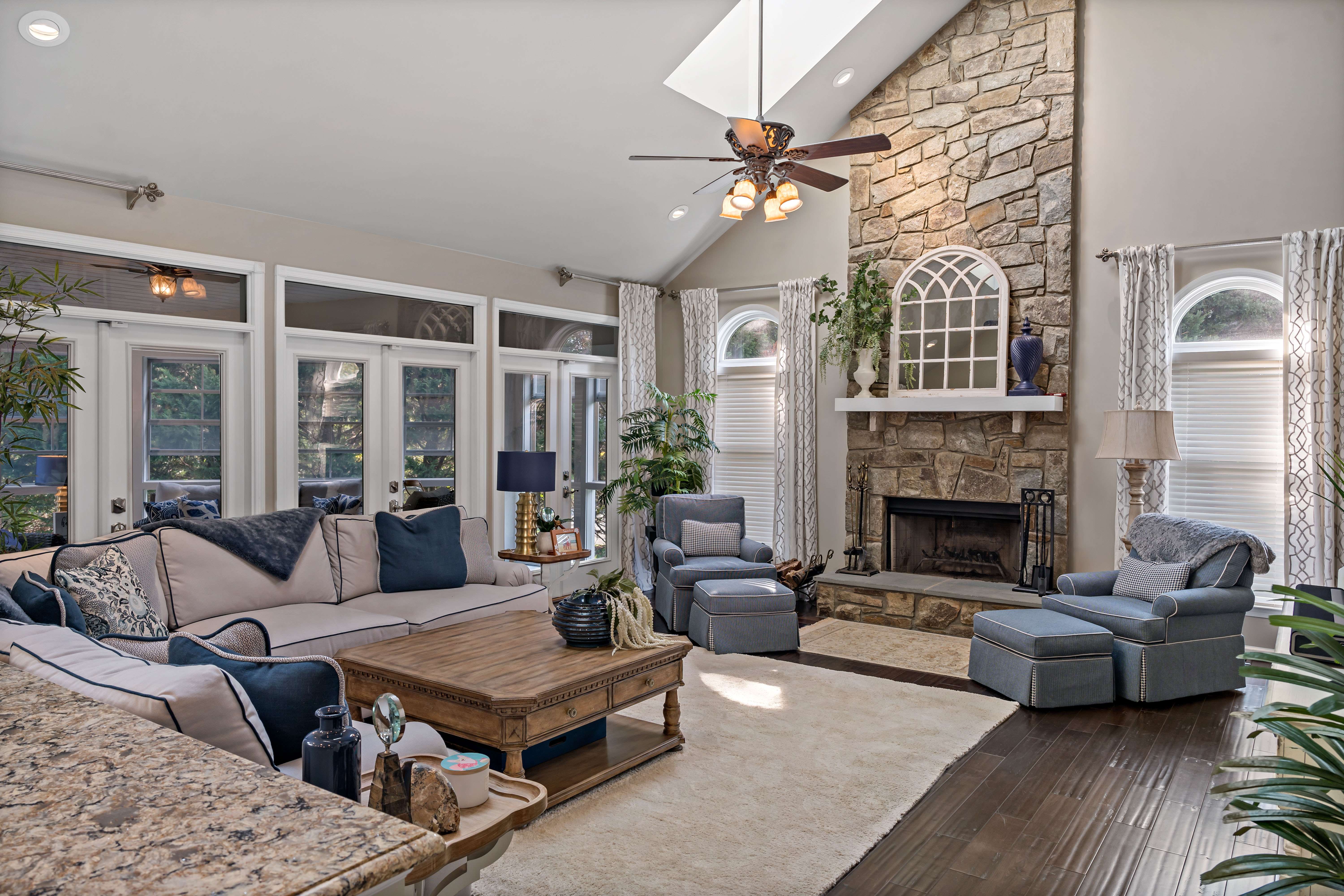 Gorgeous living room with stone fireplace and slanted ceiling