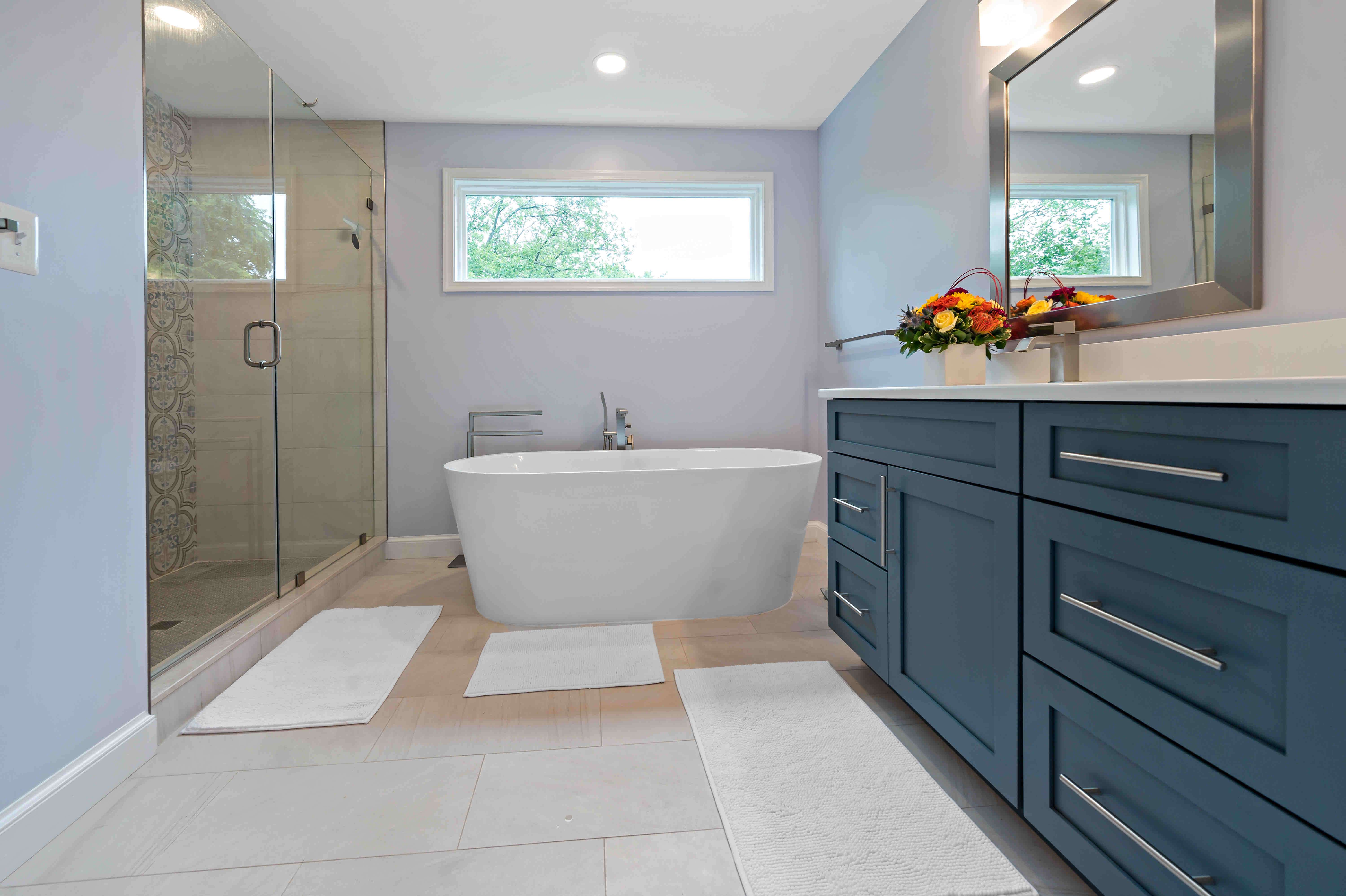 Blue cabinets and white countertops in bathroom