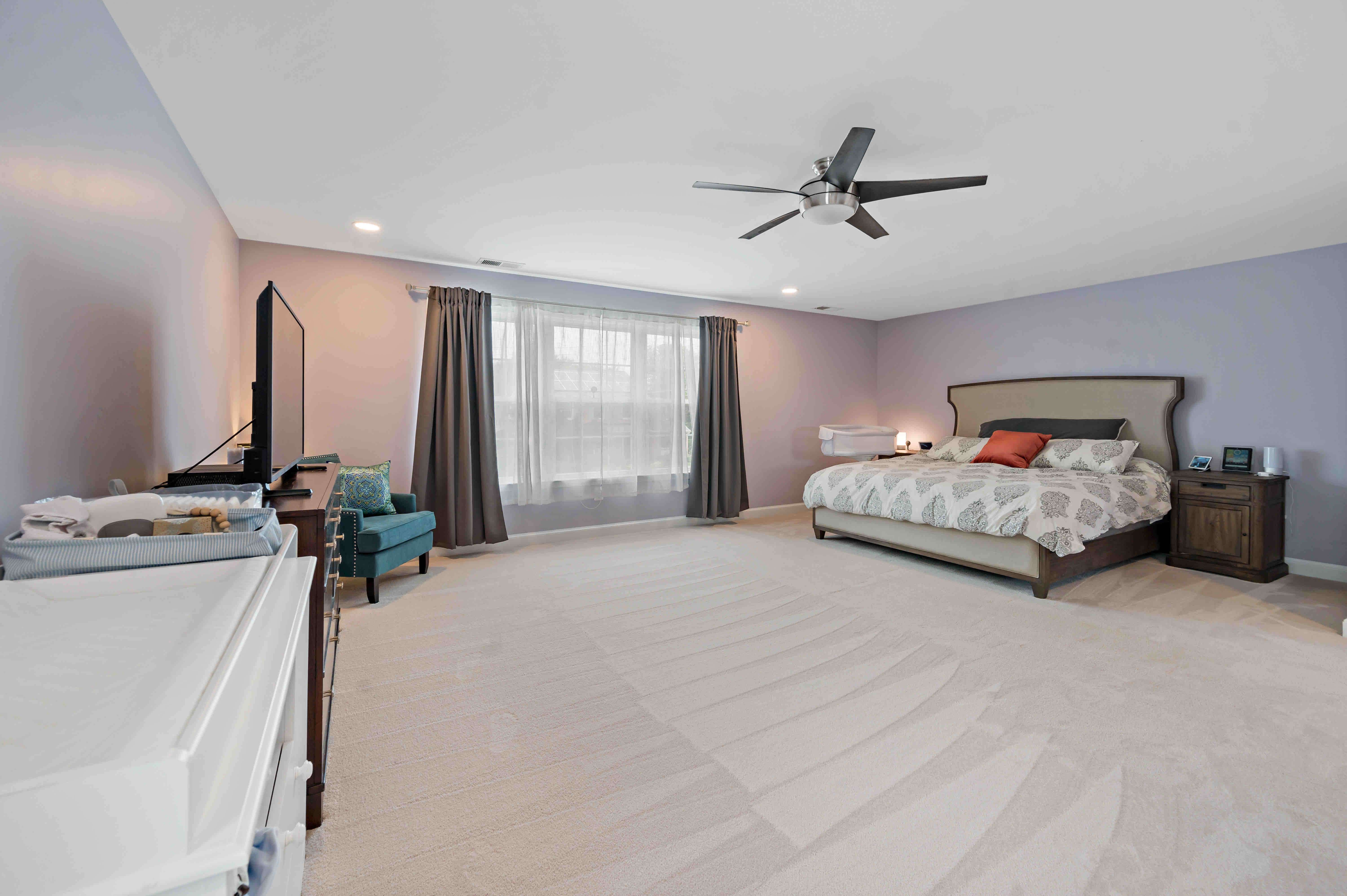 Open bedroom with light purple walls