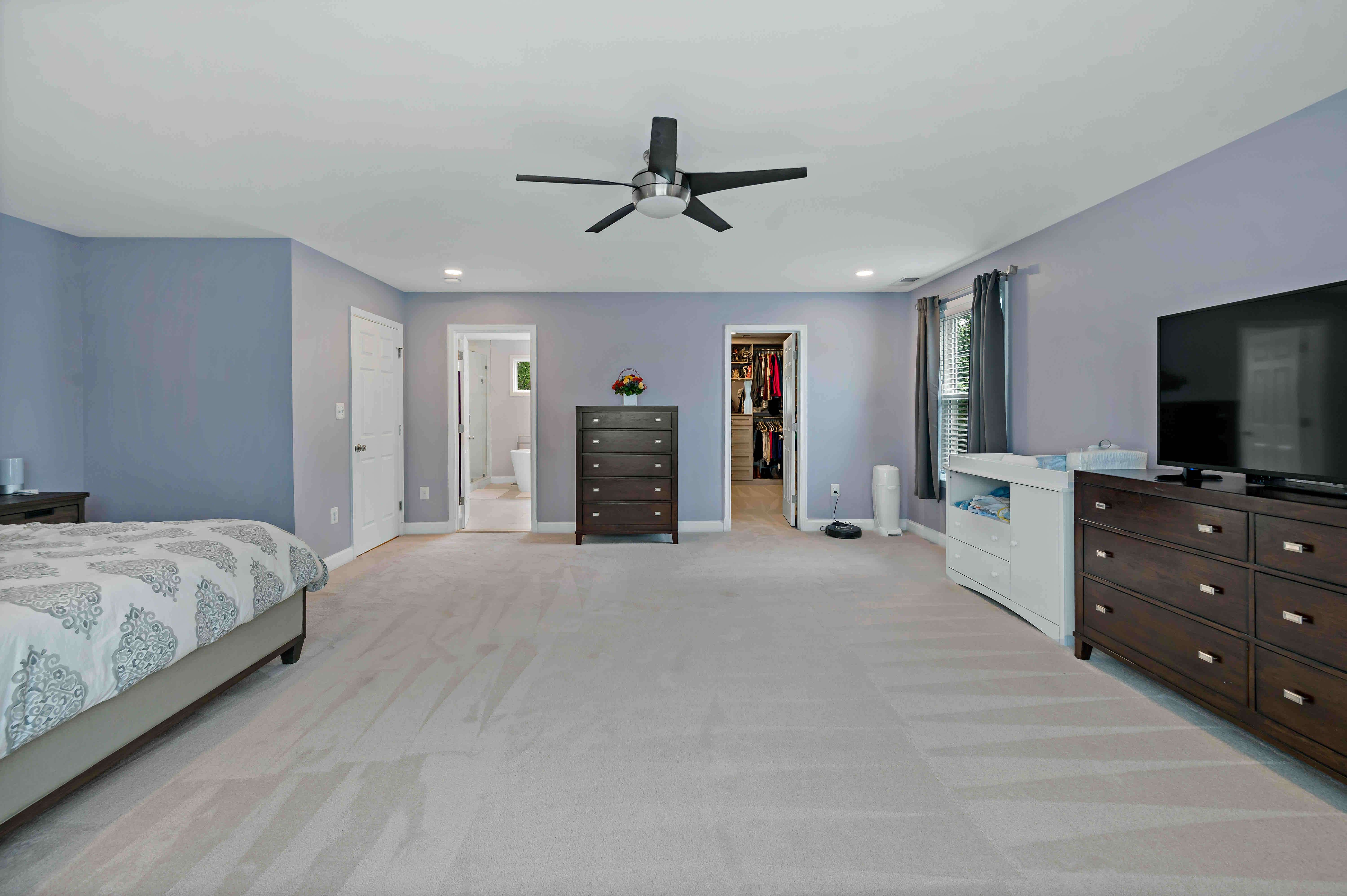 Large spacious master bedroom with ceiling fan