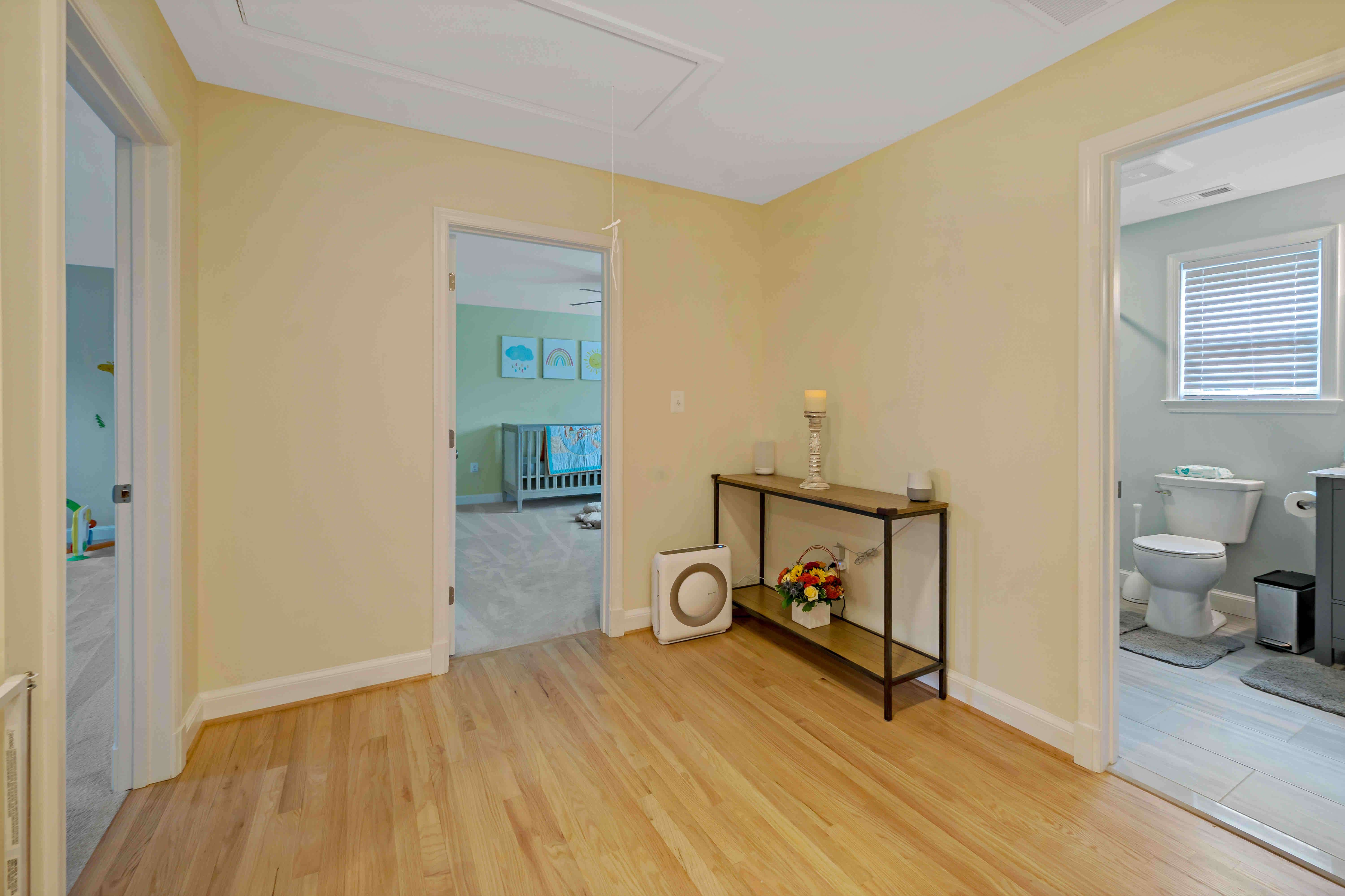 Hardwood floors and yellow walls in hallway