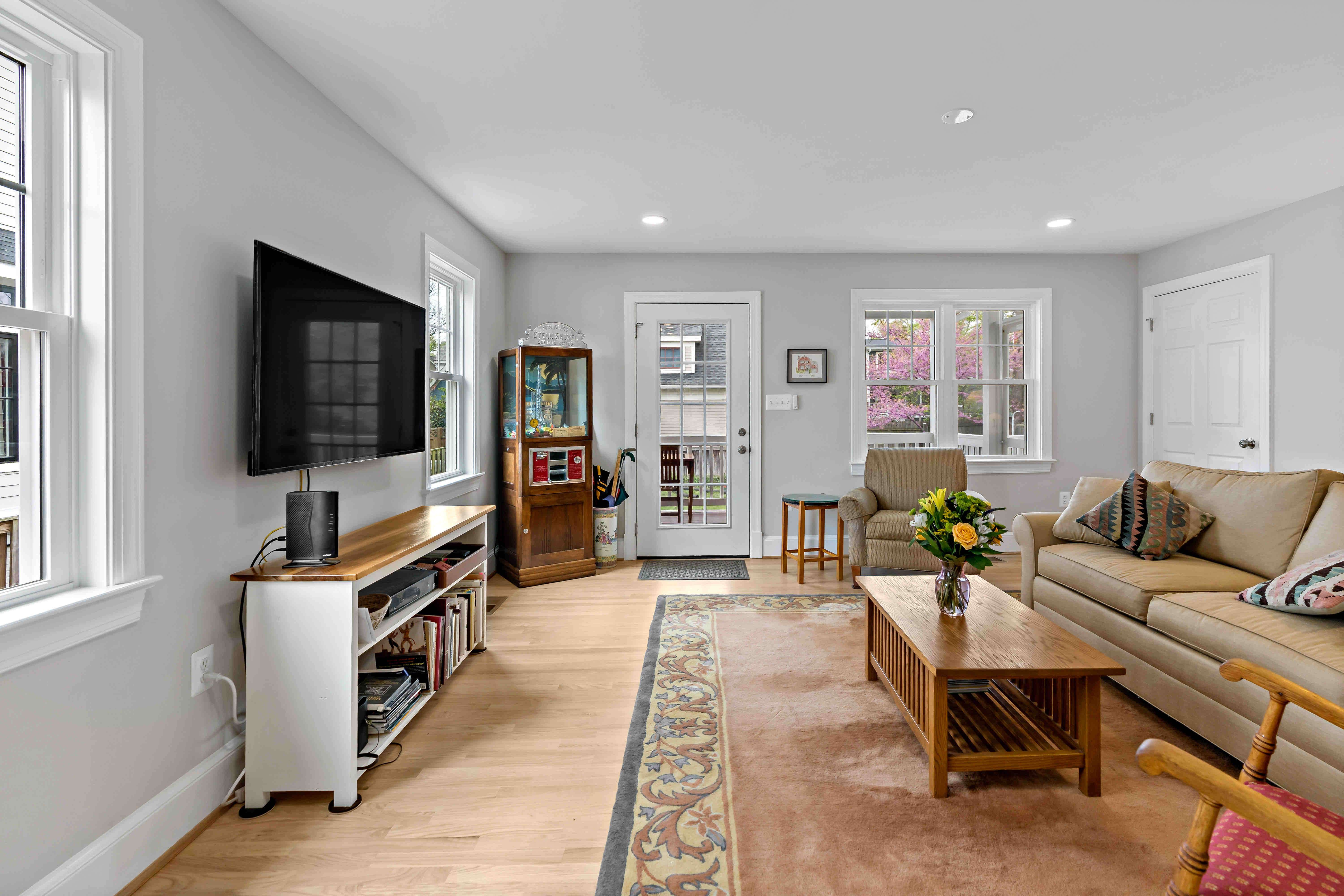 TV room with hardwood floors and large rug
