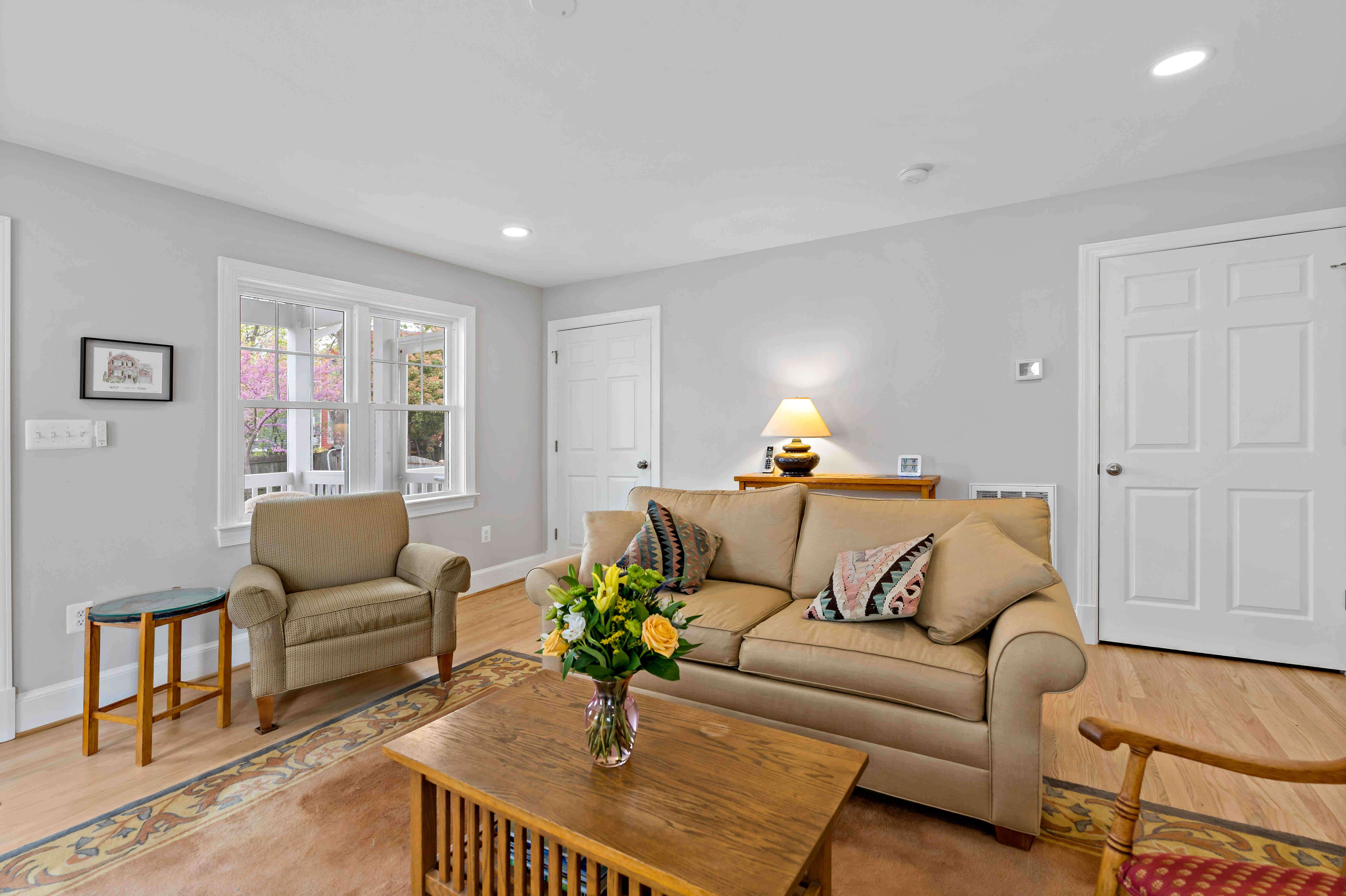 Sitting area with beige furniture and backyard view