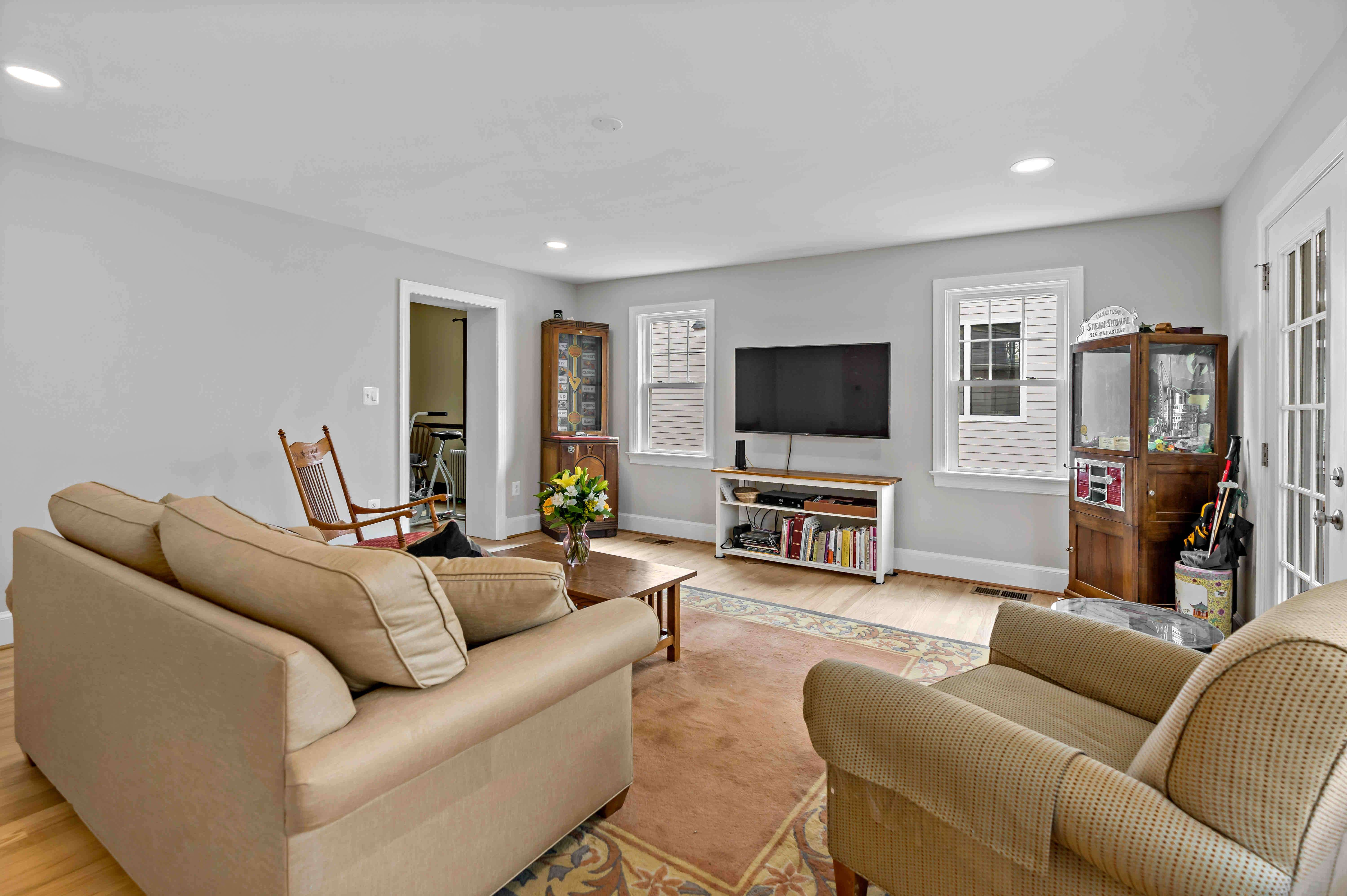 Living room with hardwood floors and white wall