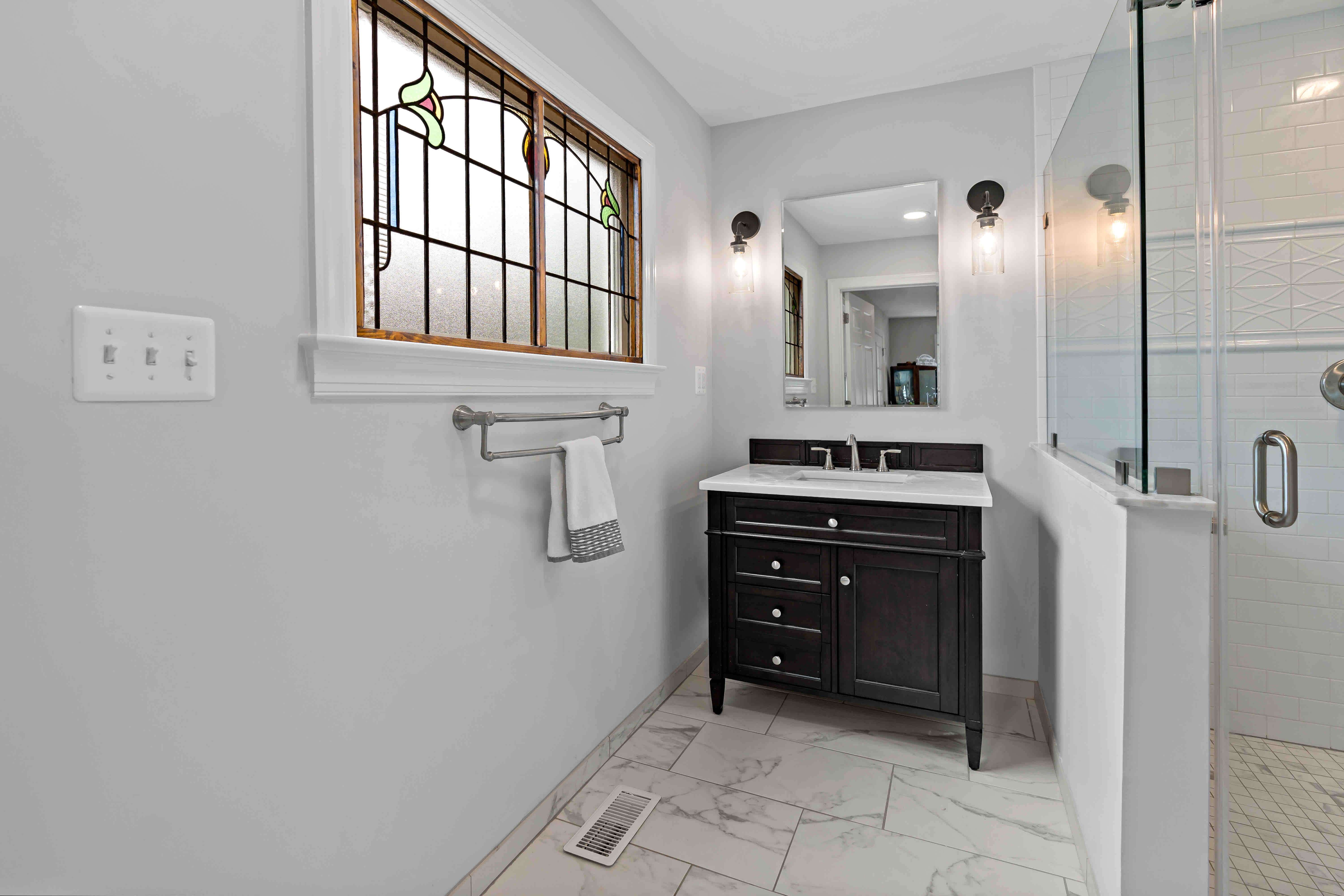 Brown window treatment and white walls in master bathroom