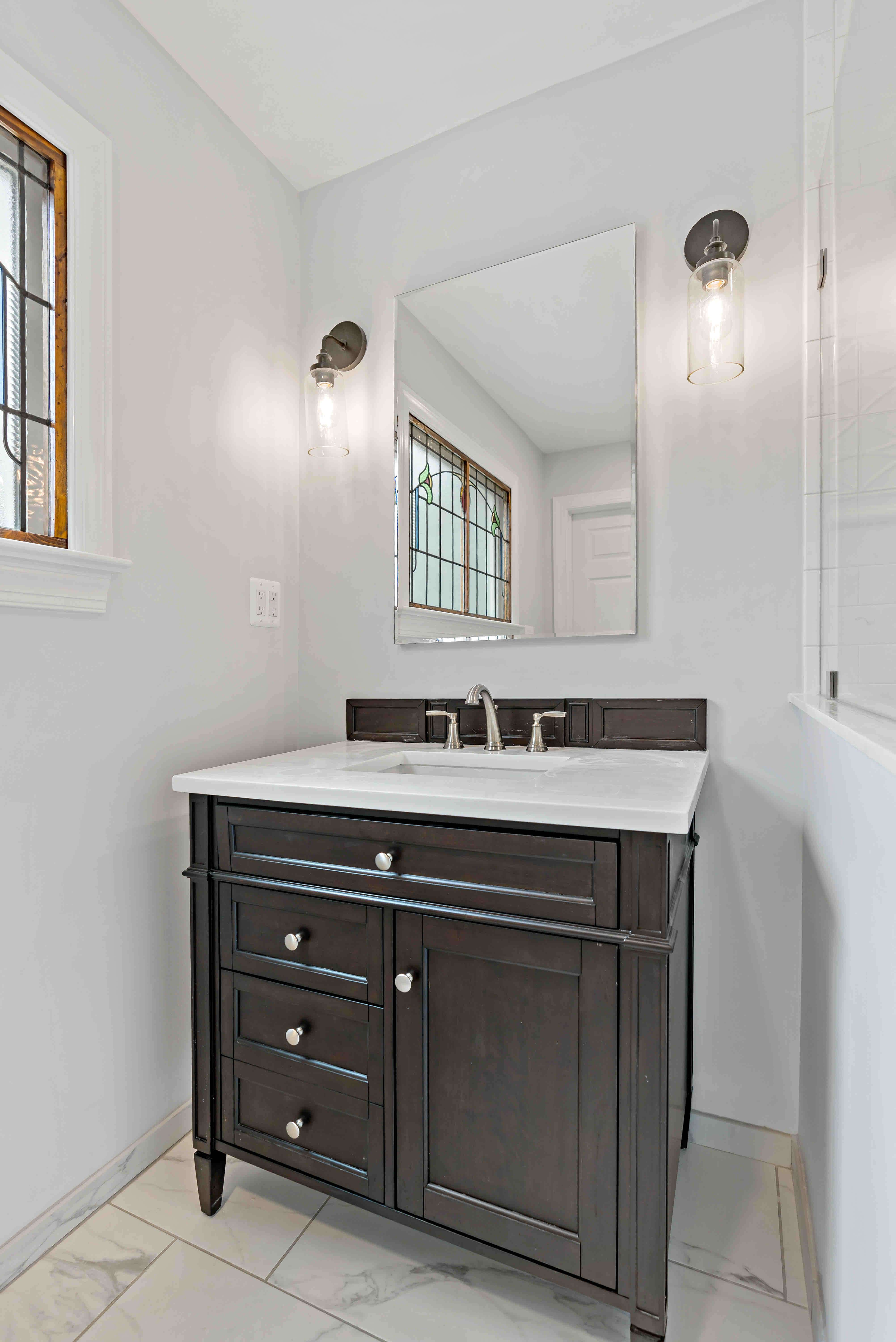 Dark brown bathroom vanity with white countertop