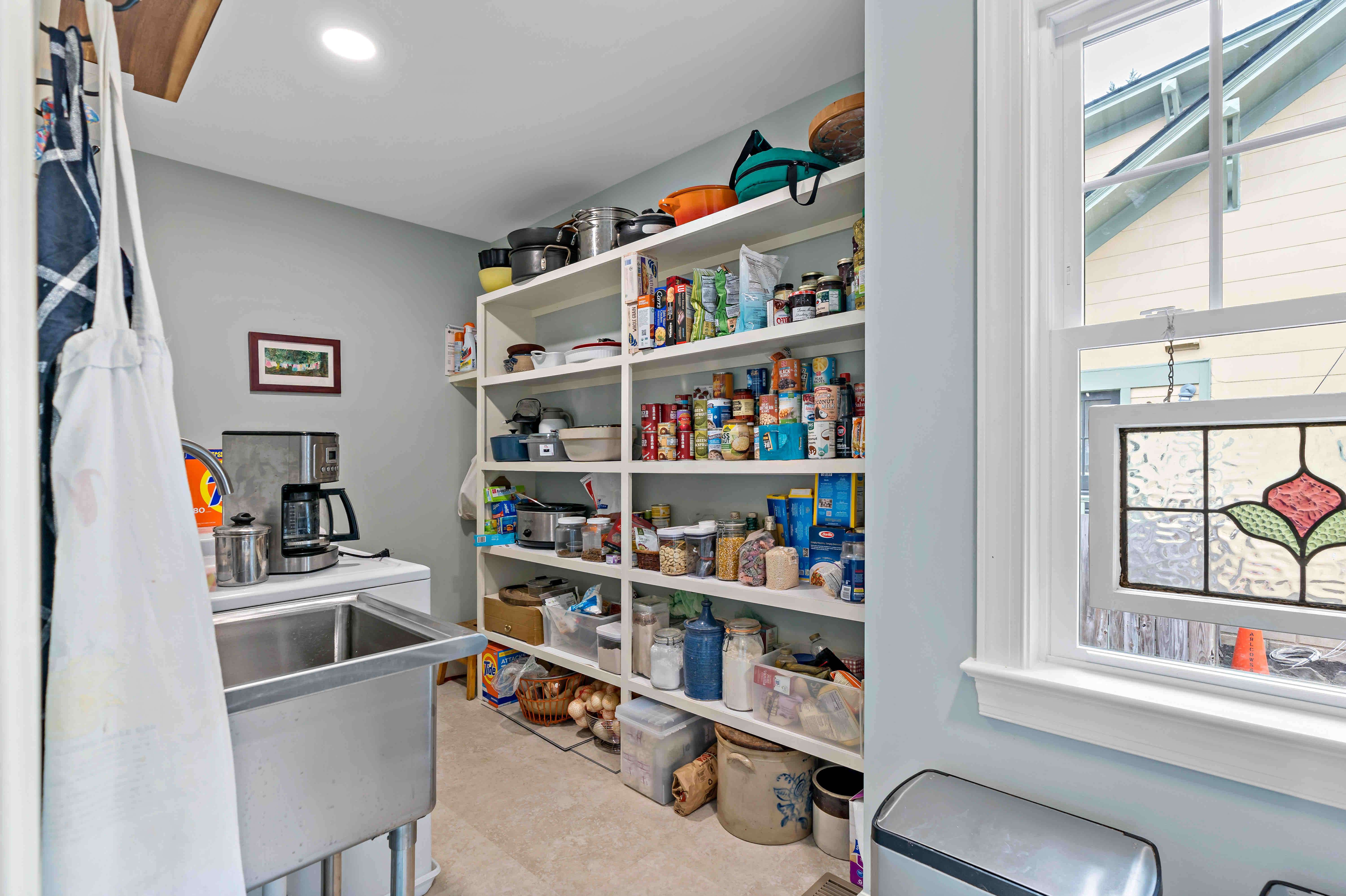 Large walk-in kitchen pantry with multiple shelves