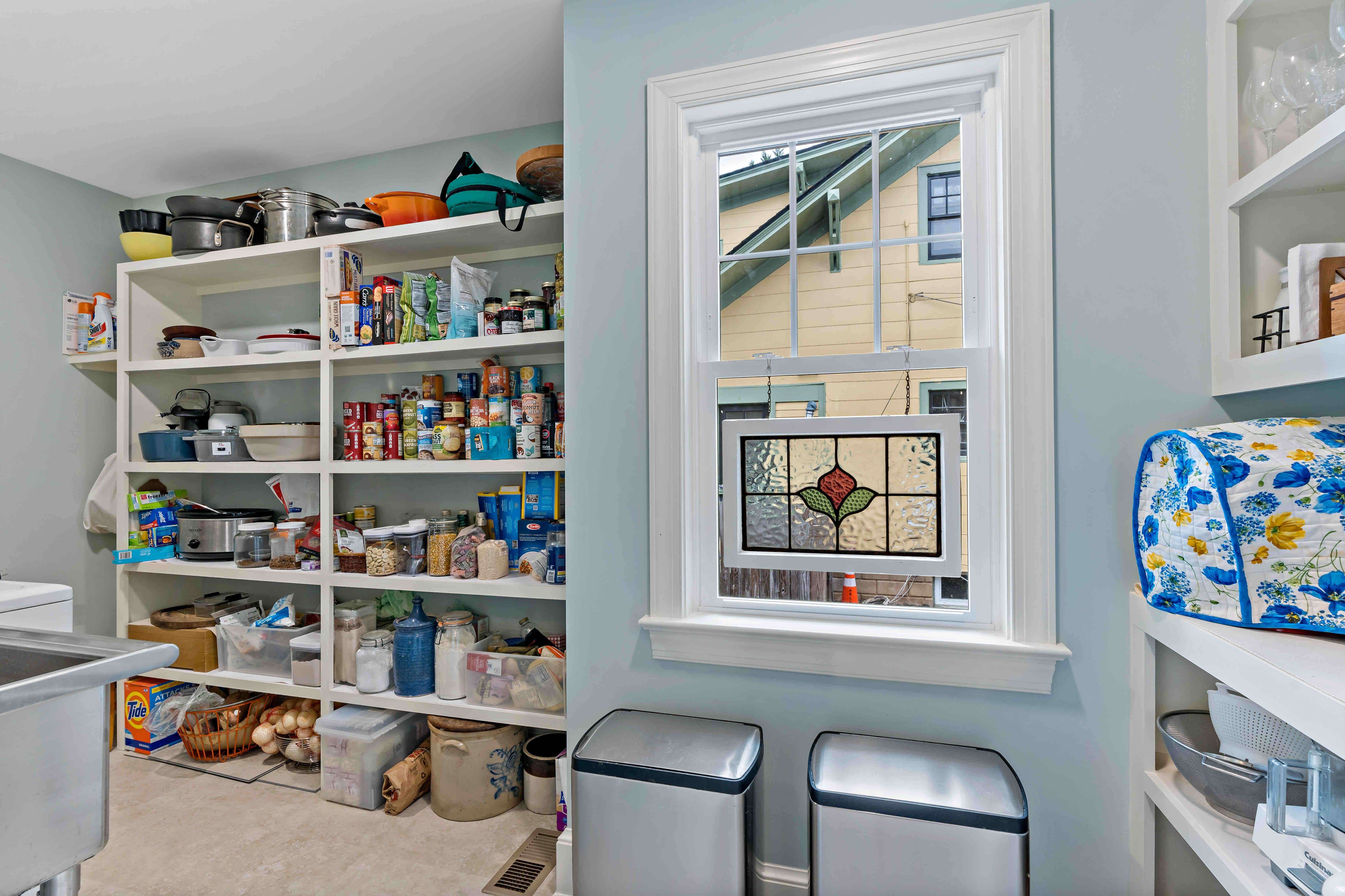 Kitchen pantry with built in shelves and window