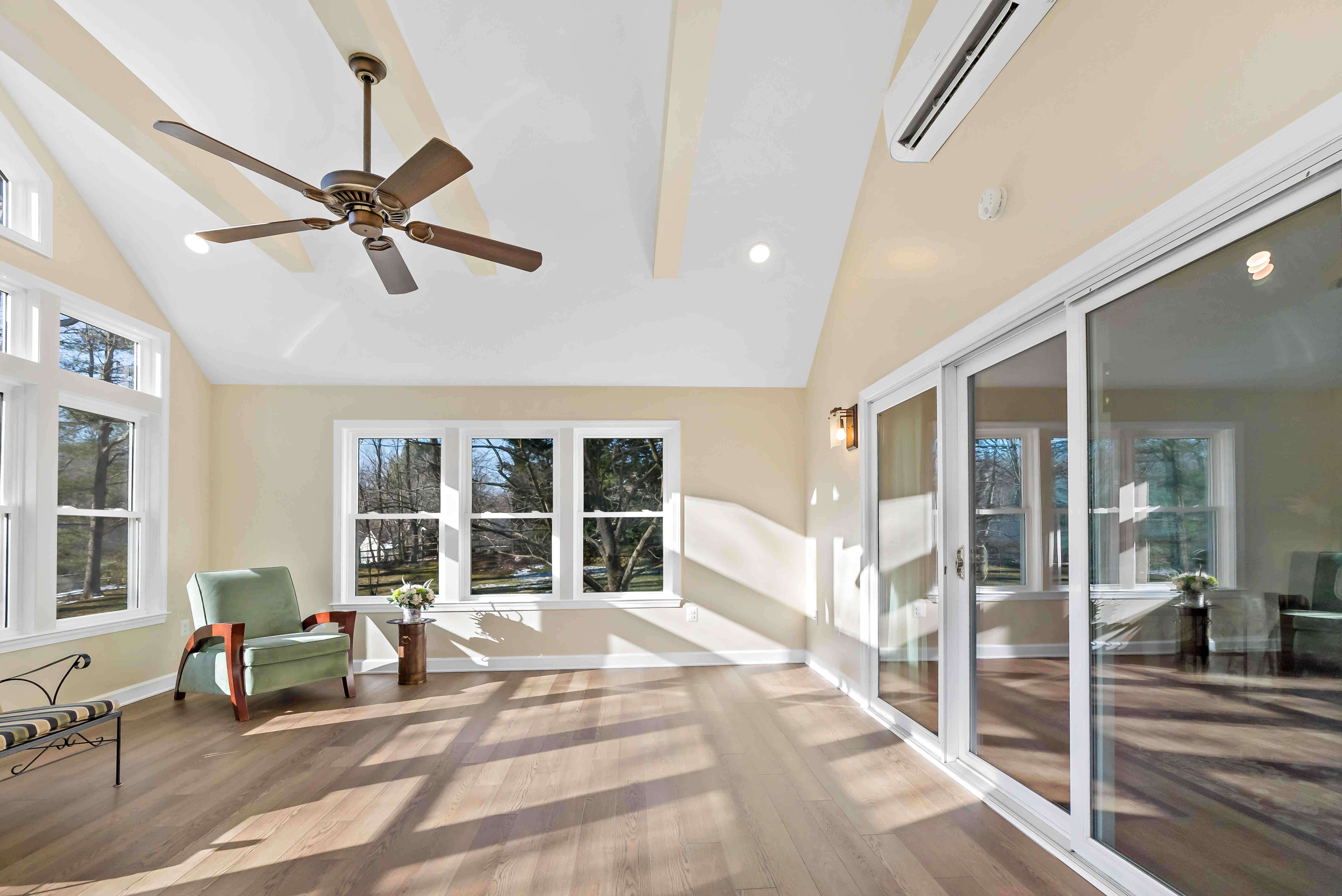Large and open concept sunroom with ceiling fan