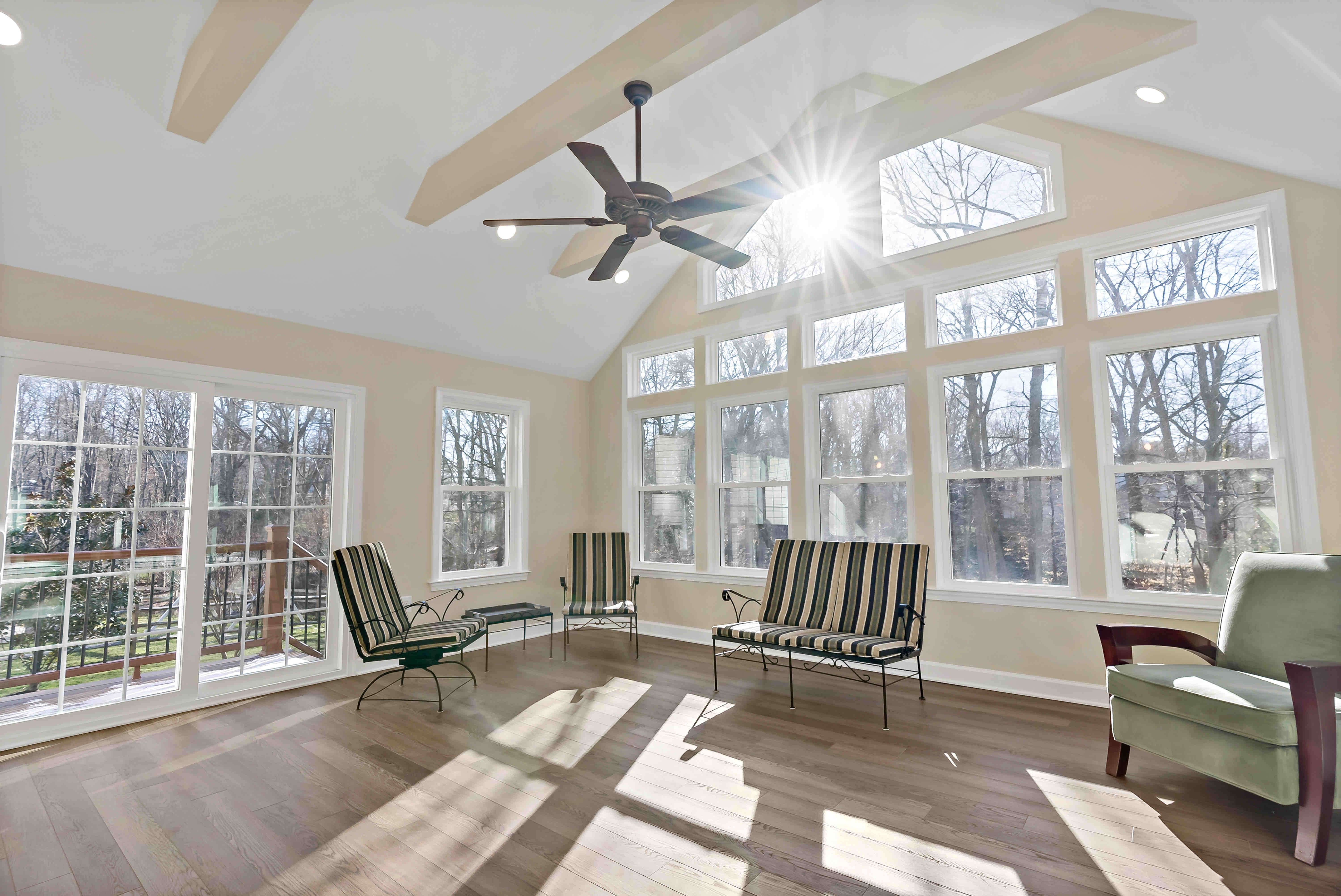 Interior of sunroom room with cathedral ceiling and ceiling fan