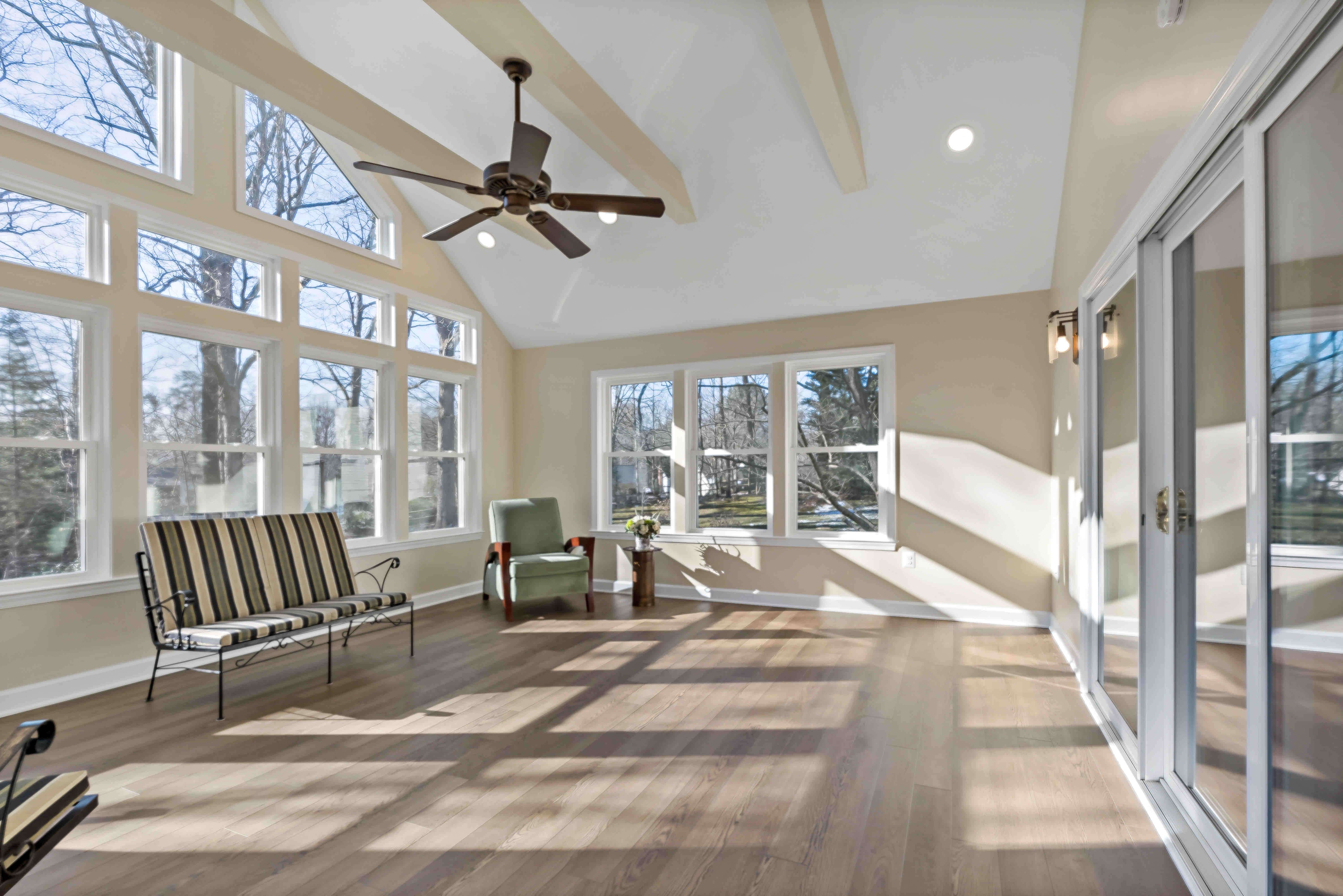 Open and spacious sunroom with hardwood floors