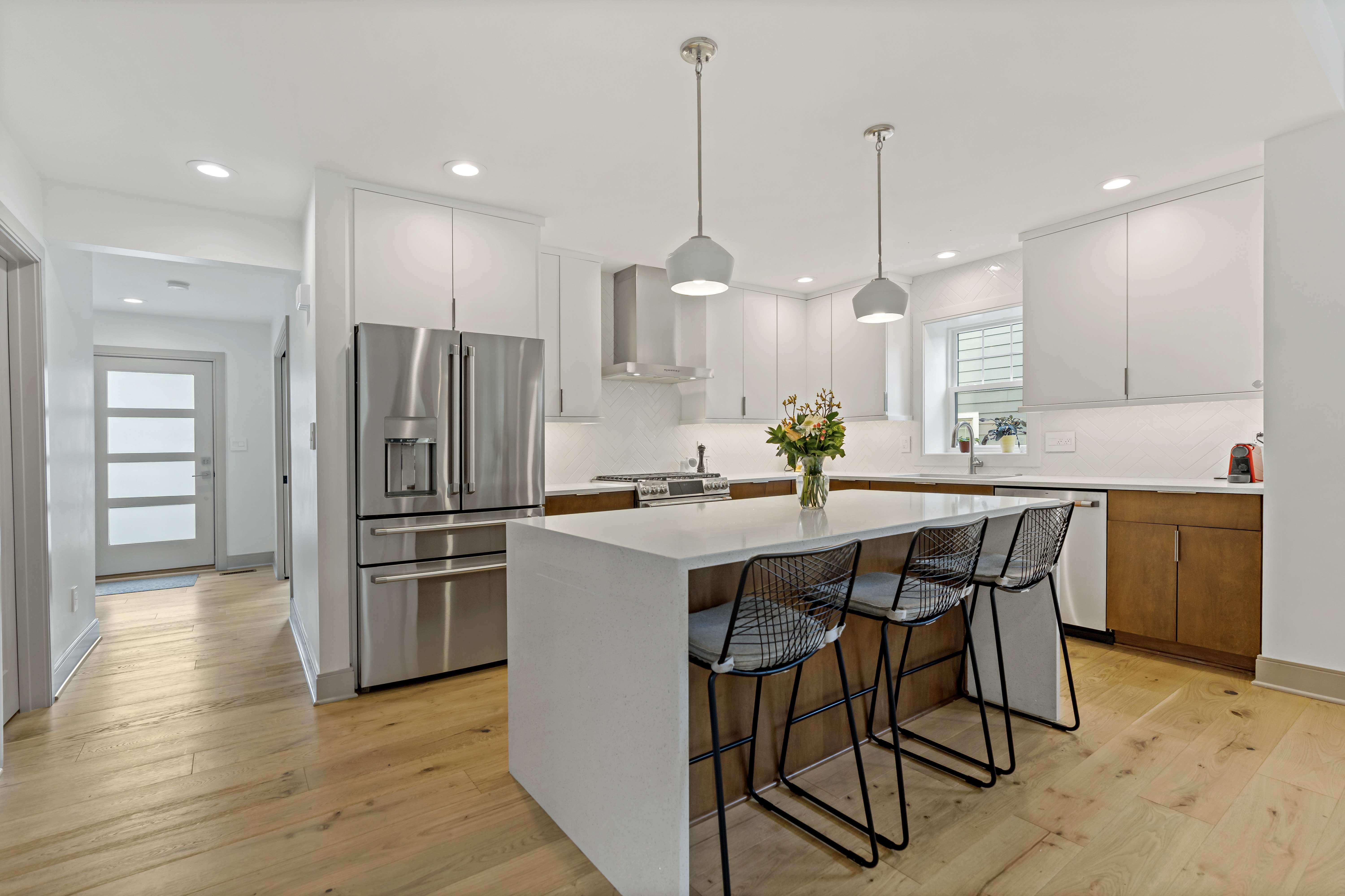 White kitchen island with seating on one side