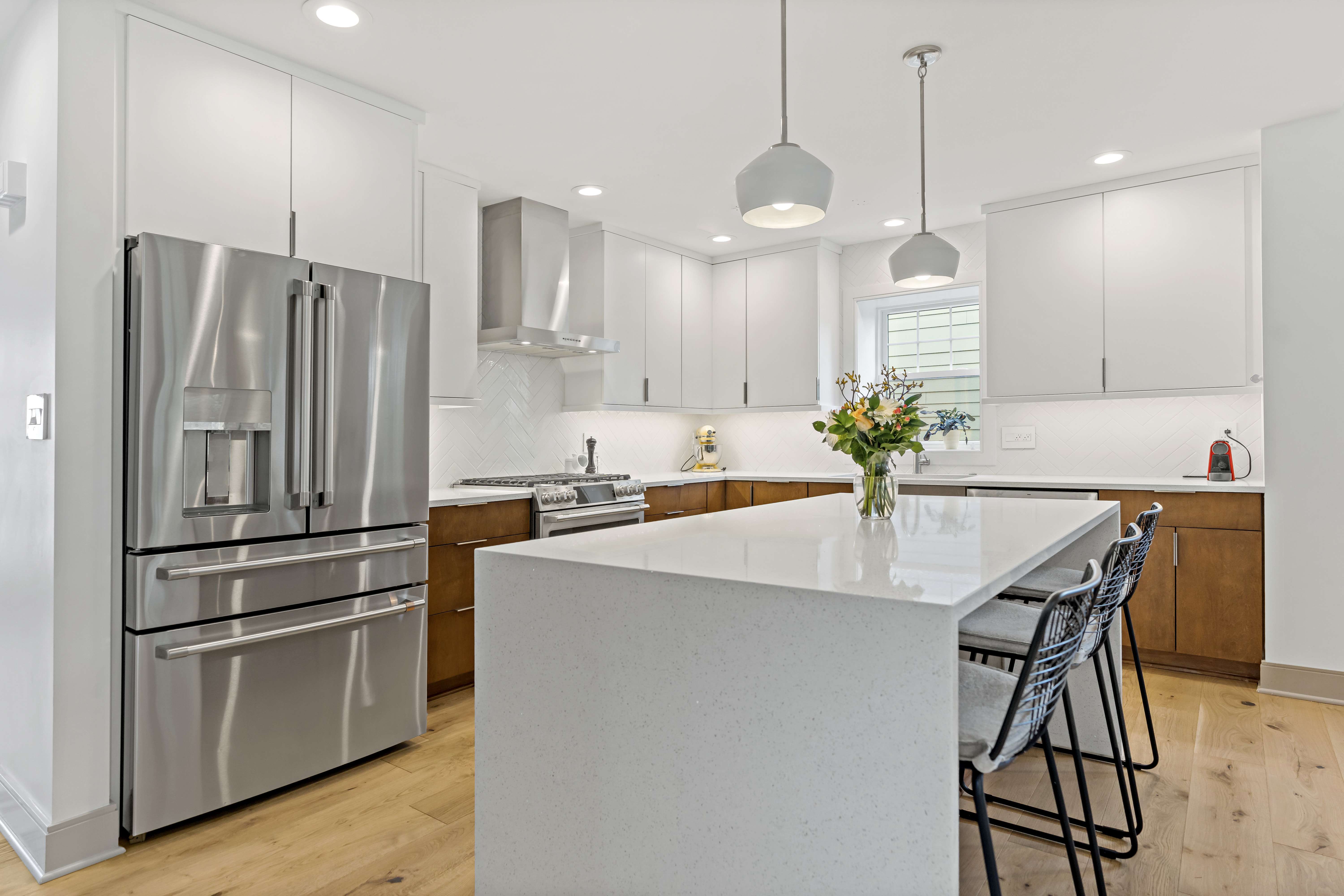 Silver appliances in white Arlington kitchen with hard wood floors