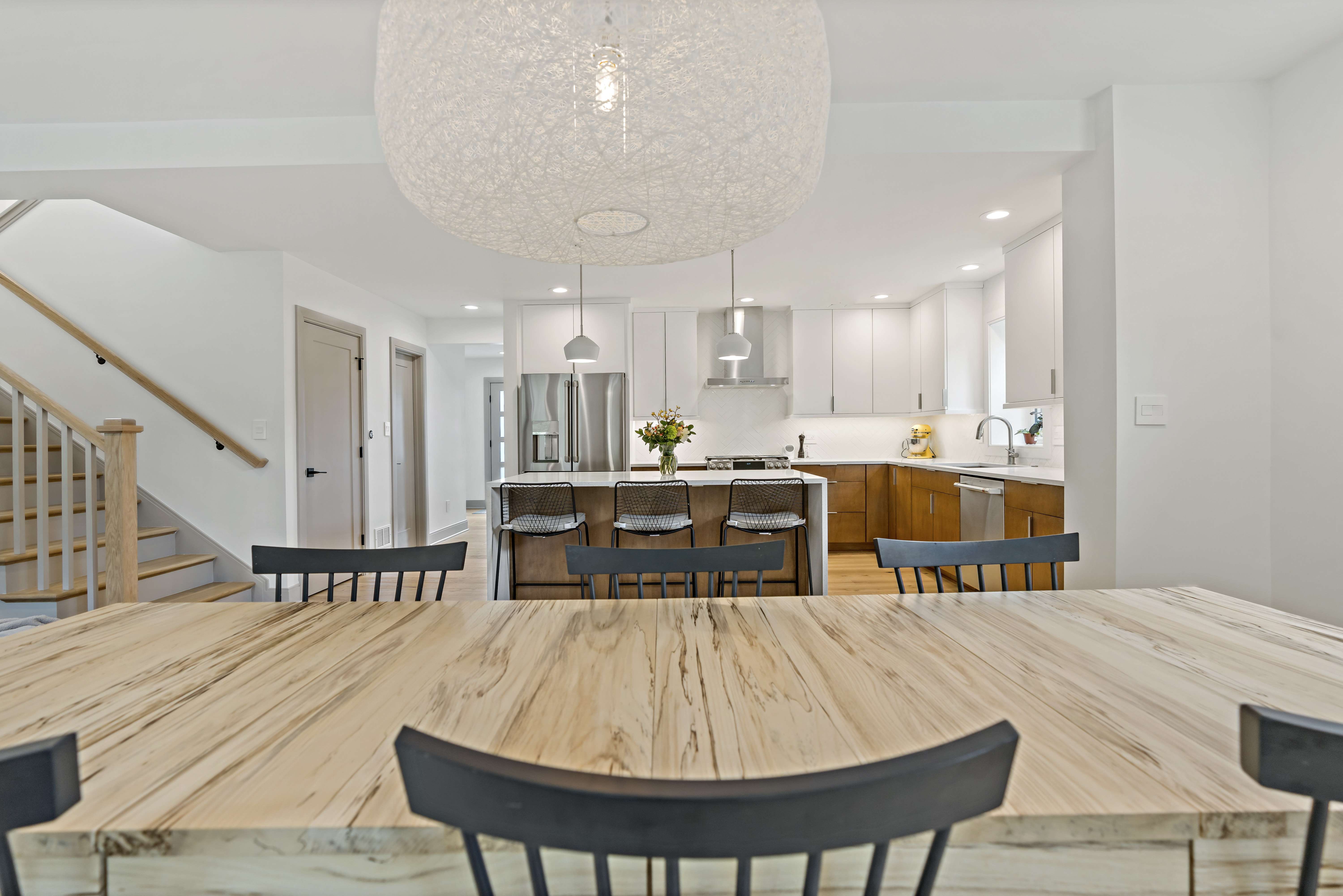 Kitchen table with chandelier overlooking entire kitchen