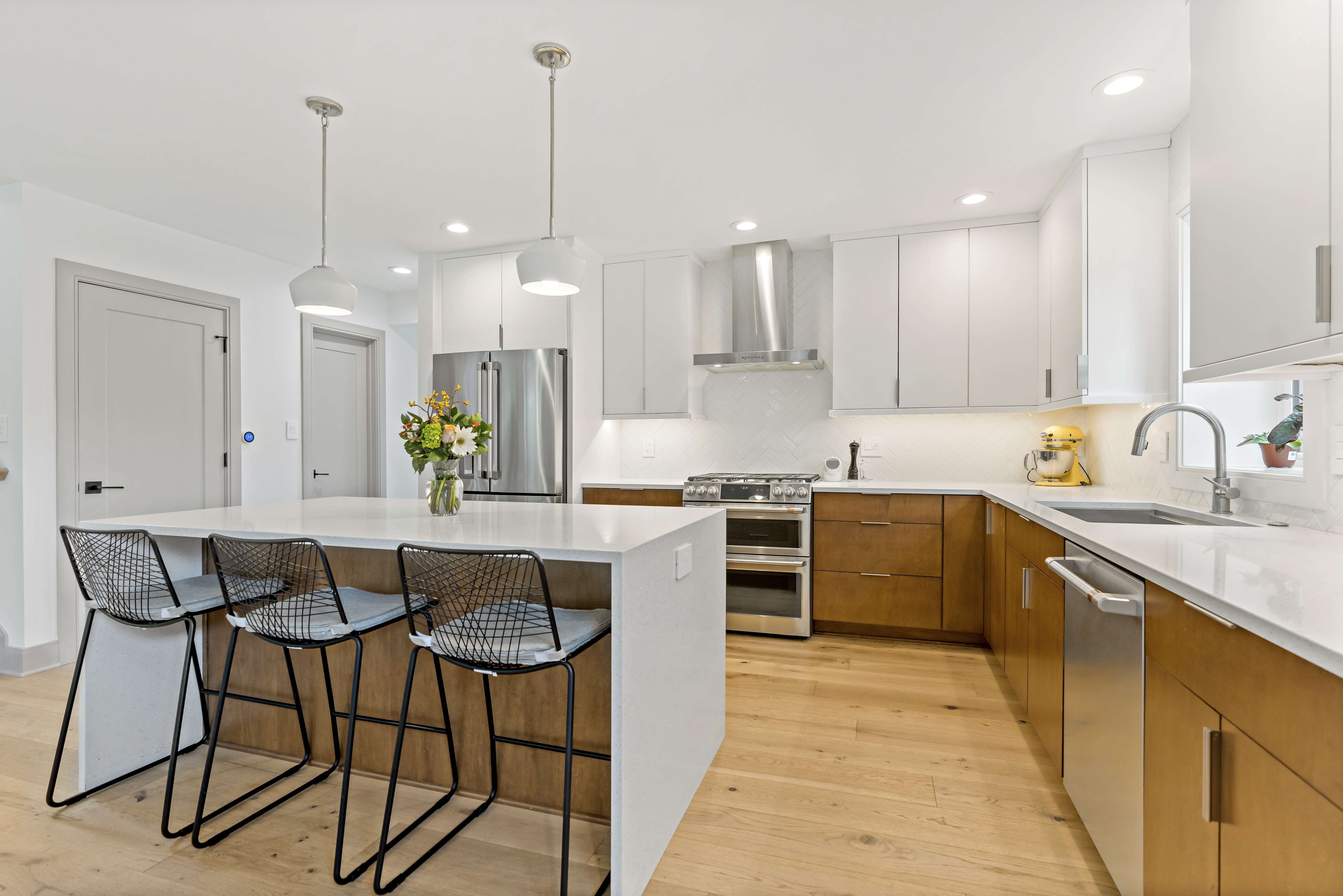 White kitchen with light brown wood accents