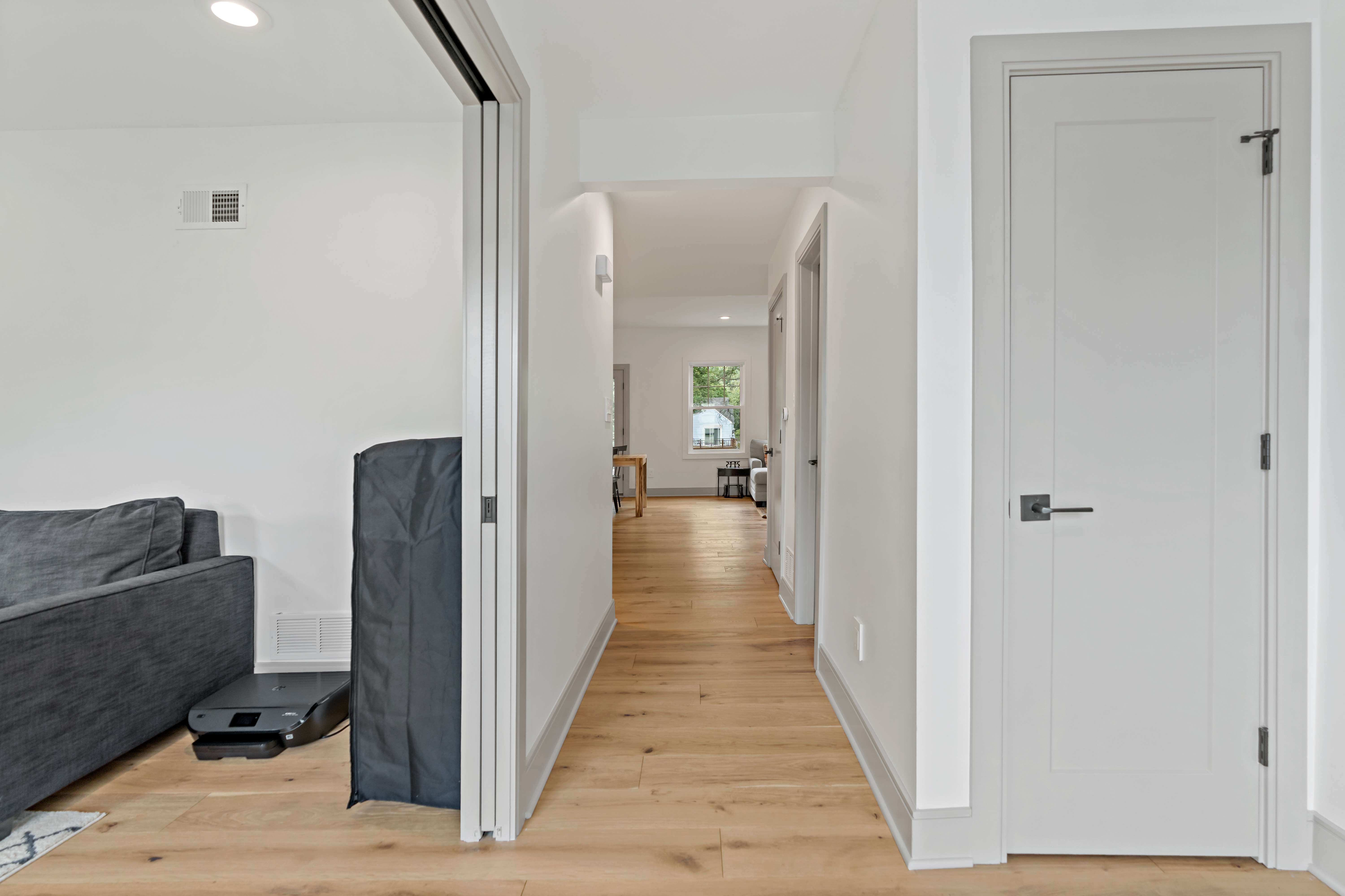 Hardwood floor hallway with white walls