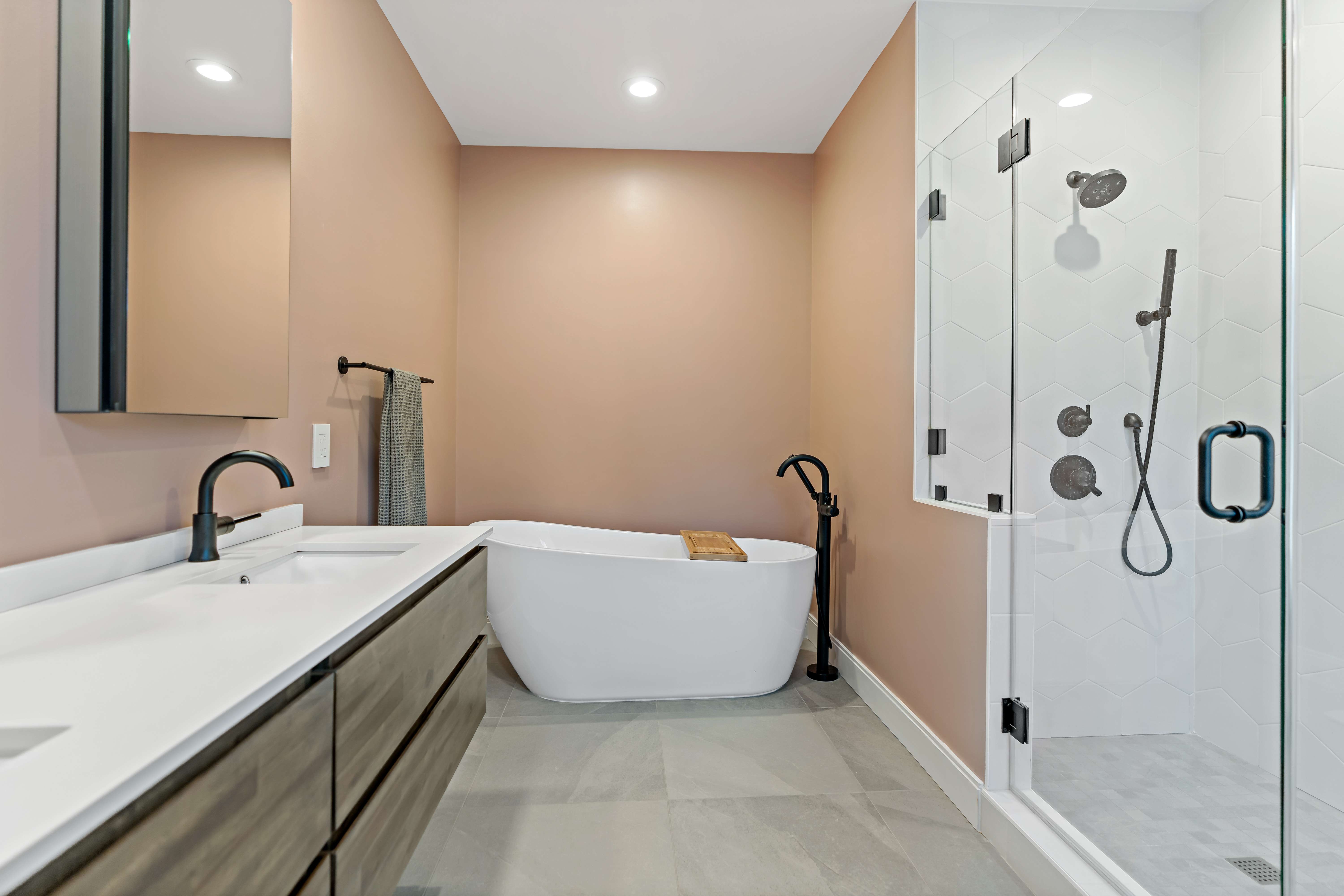 Stand up shower with glass walls and black bathroom fixtures