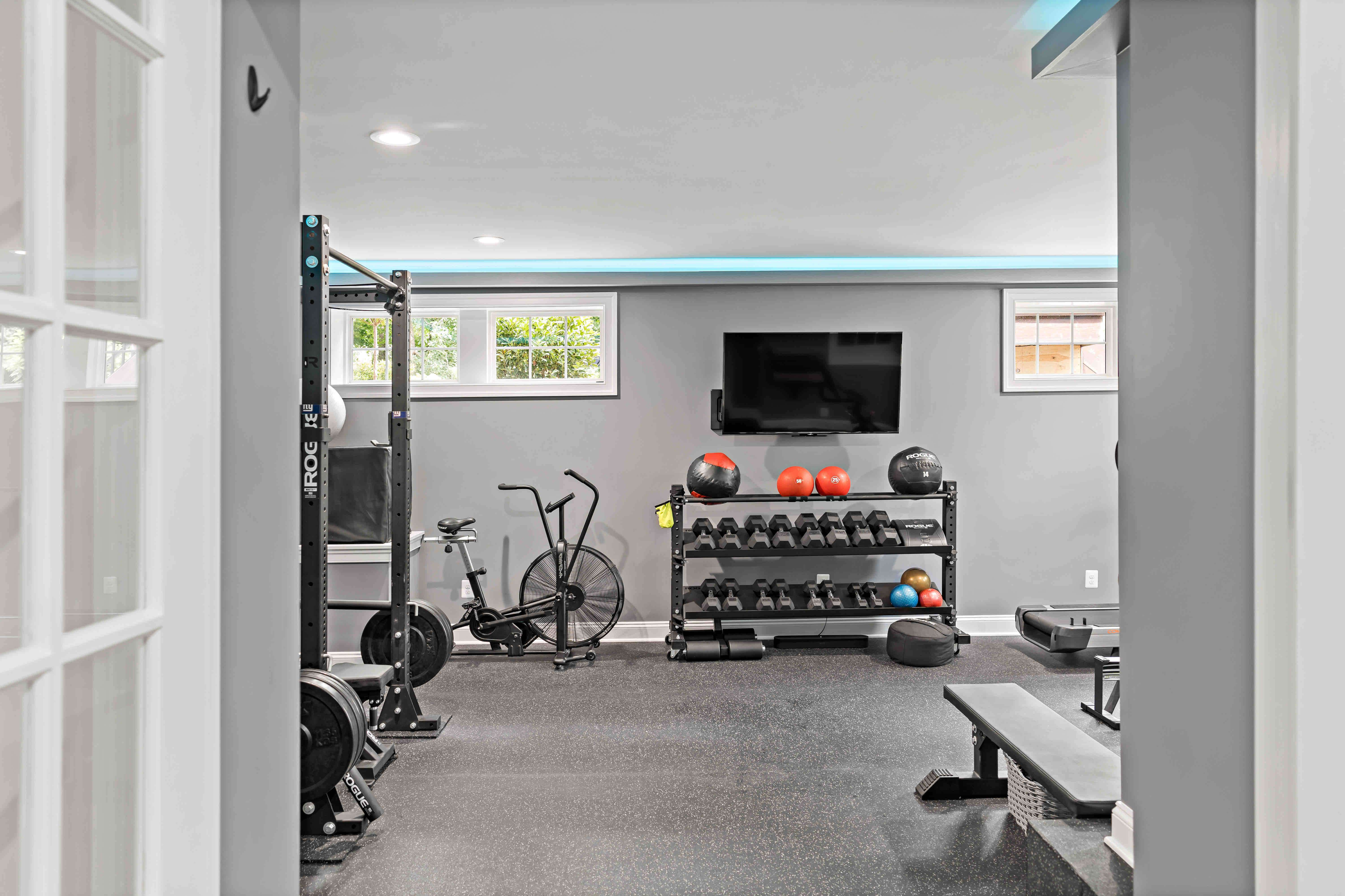 Entrance to fully stoocked home gym with grey walls