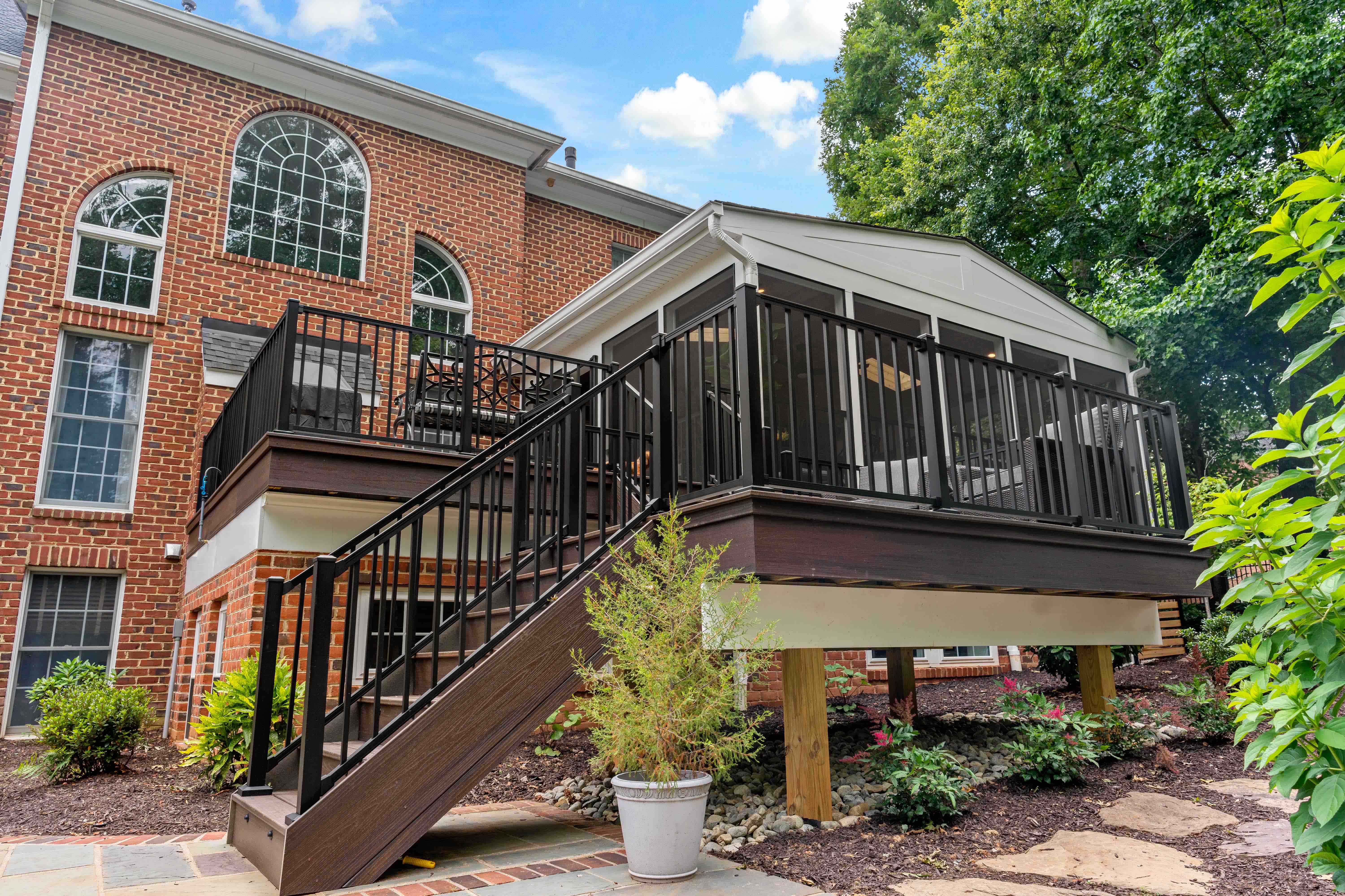 Exterior look of raised screened porch with stairs to enter and exit