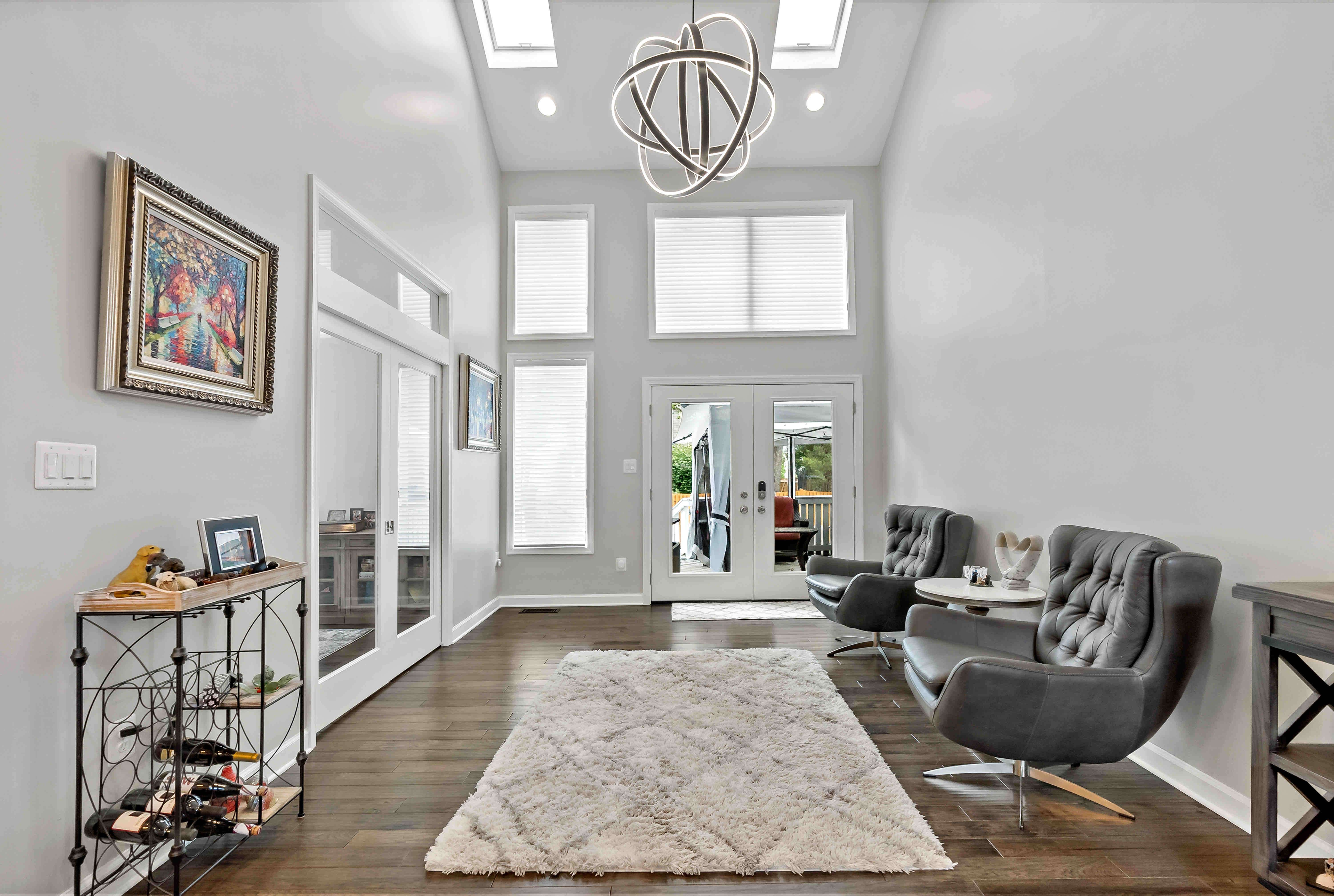 Foyer with seating and round chandelier pendant
