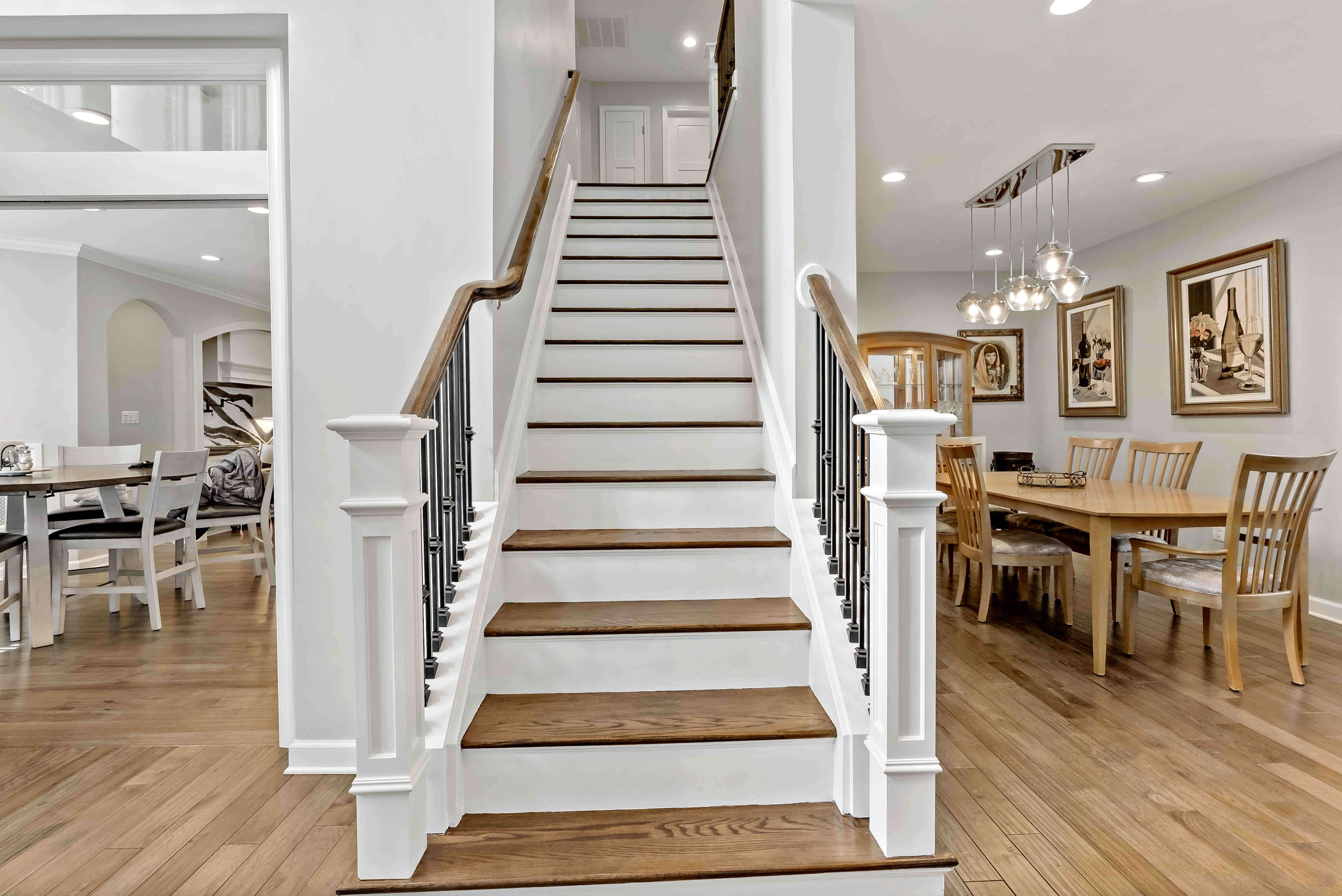 Wooden staircase white and brown in center of home