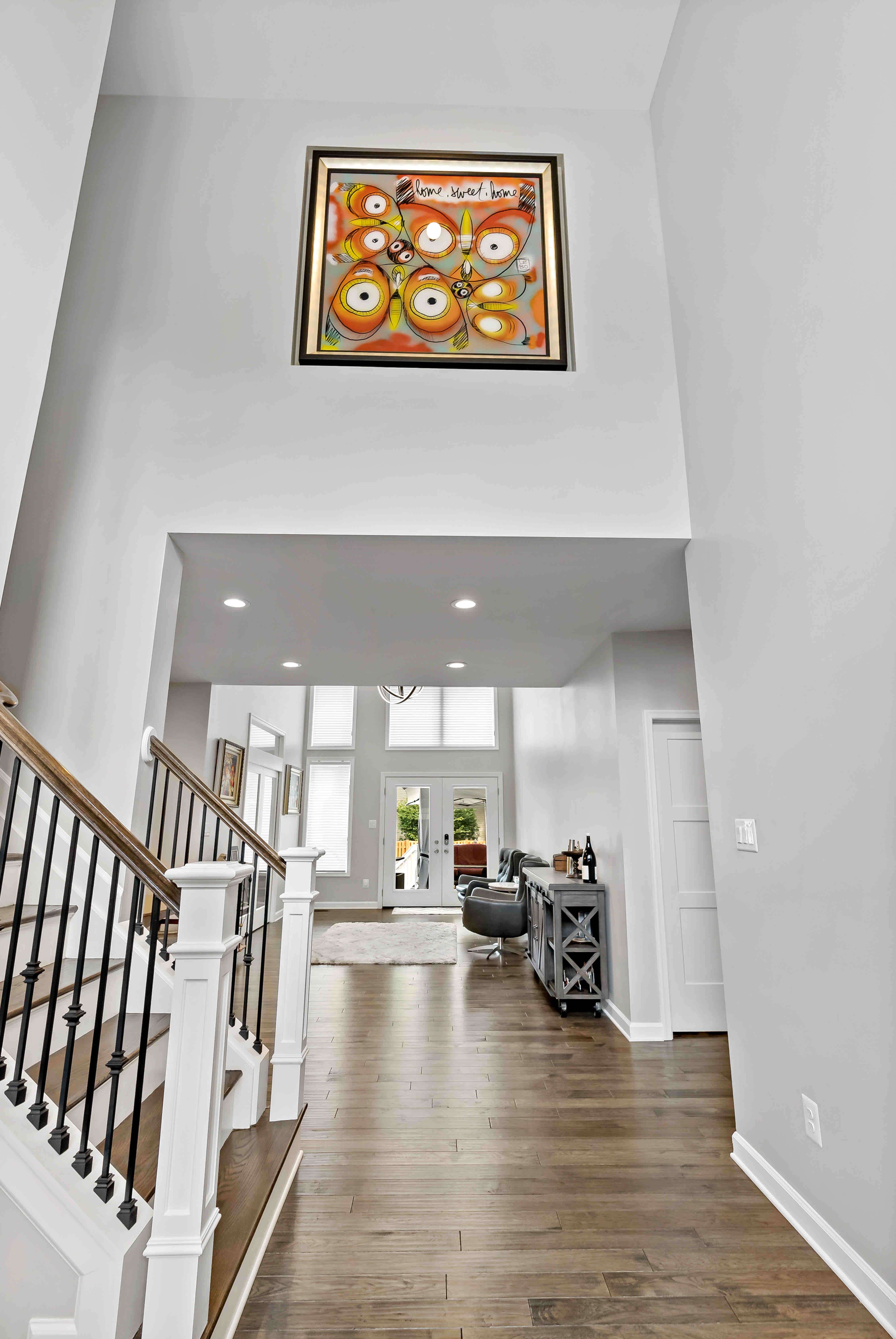 Hardwood floor foyer with staircase