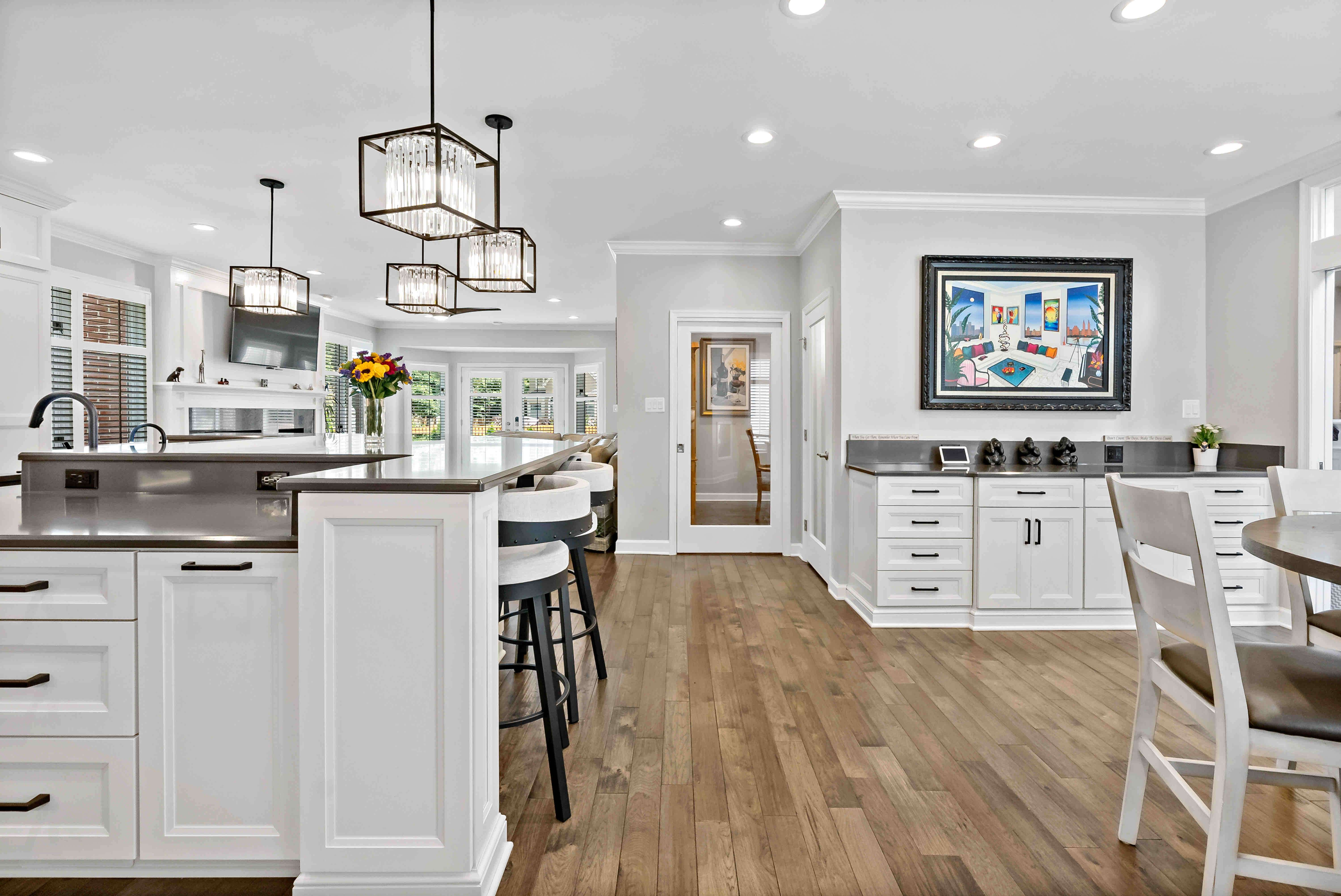 Hardwood floor kitchen with white cabinets