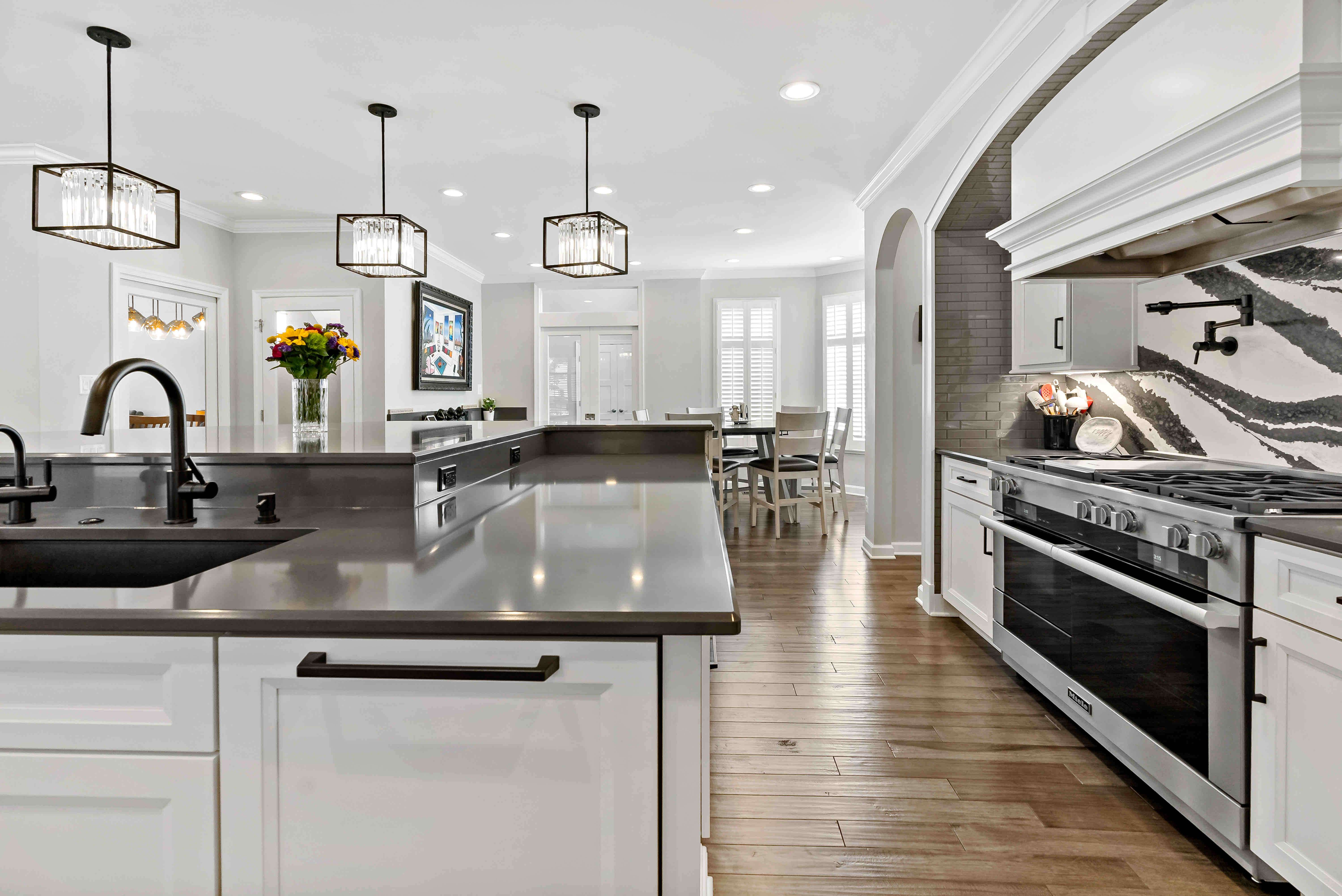 Dark kitchen countertops with marble backsplash