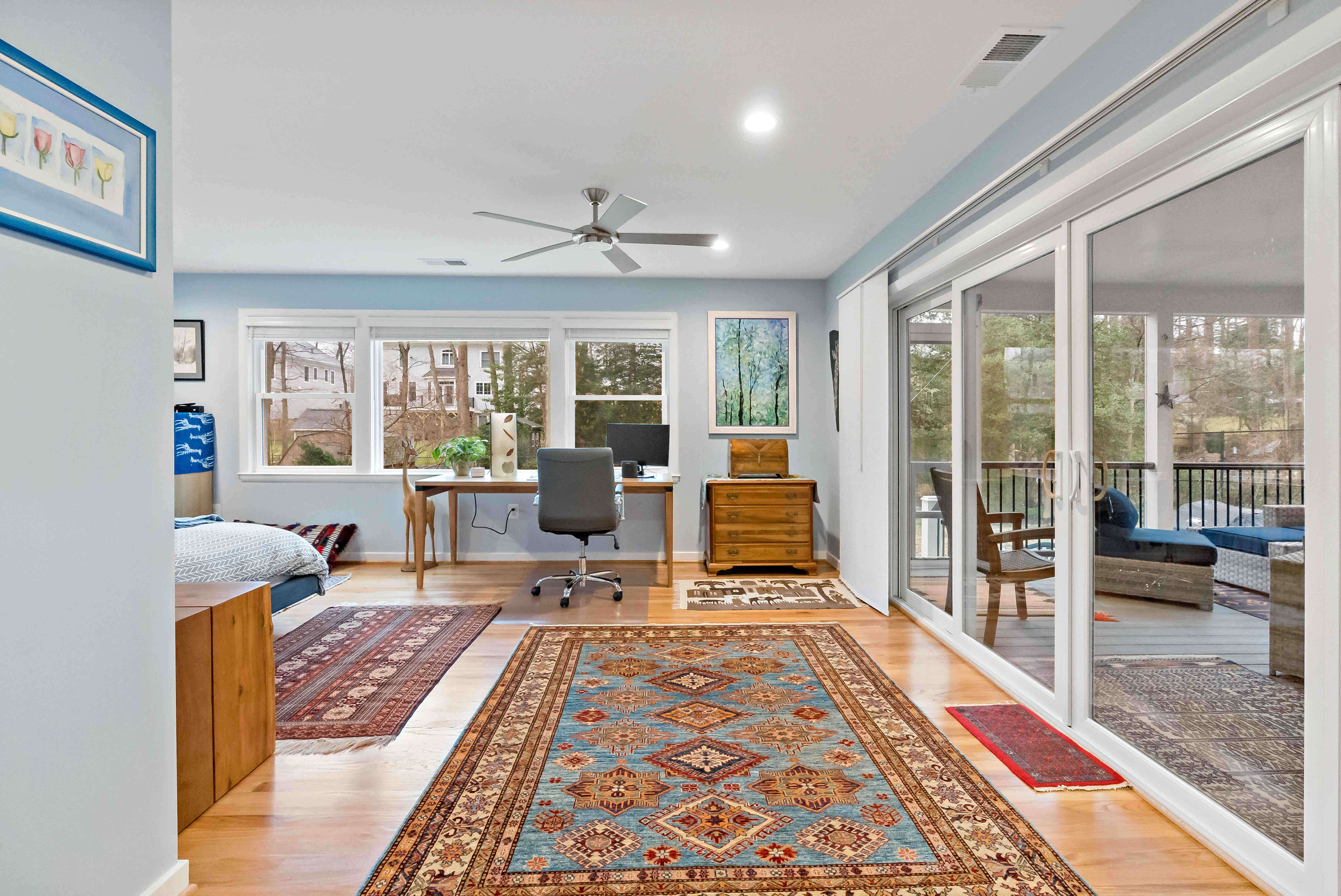 Hardwood flooring in bedroom with desk area
