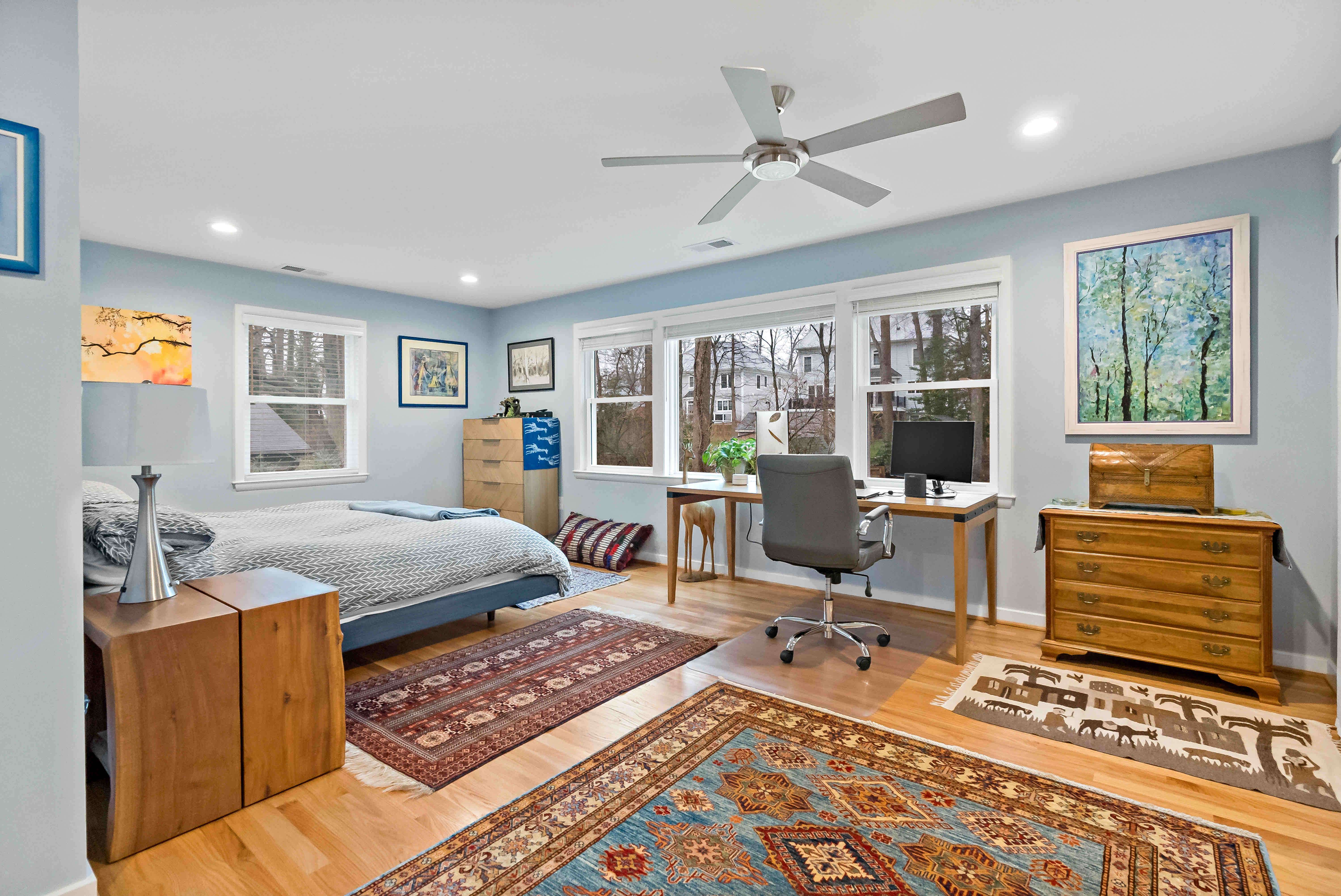 Hardwood flooring and rugs in bedroom