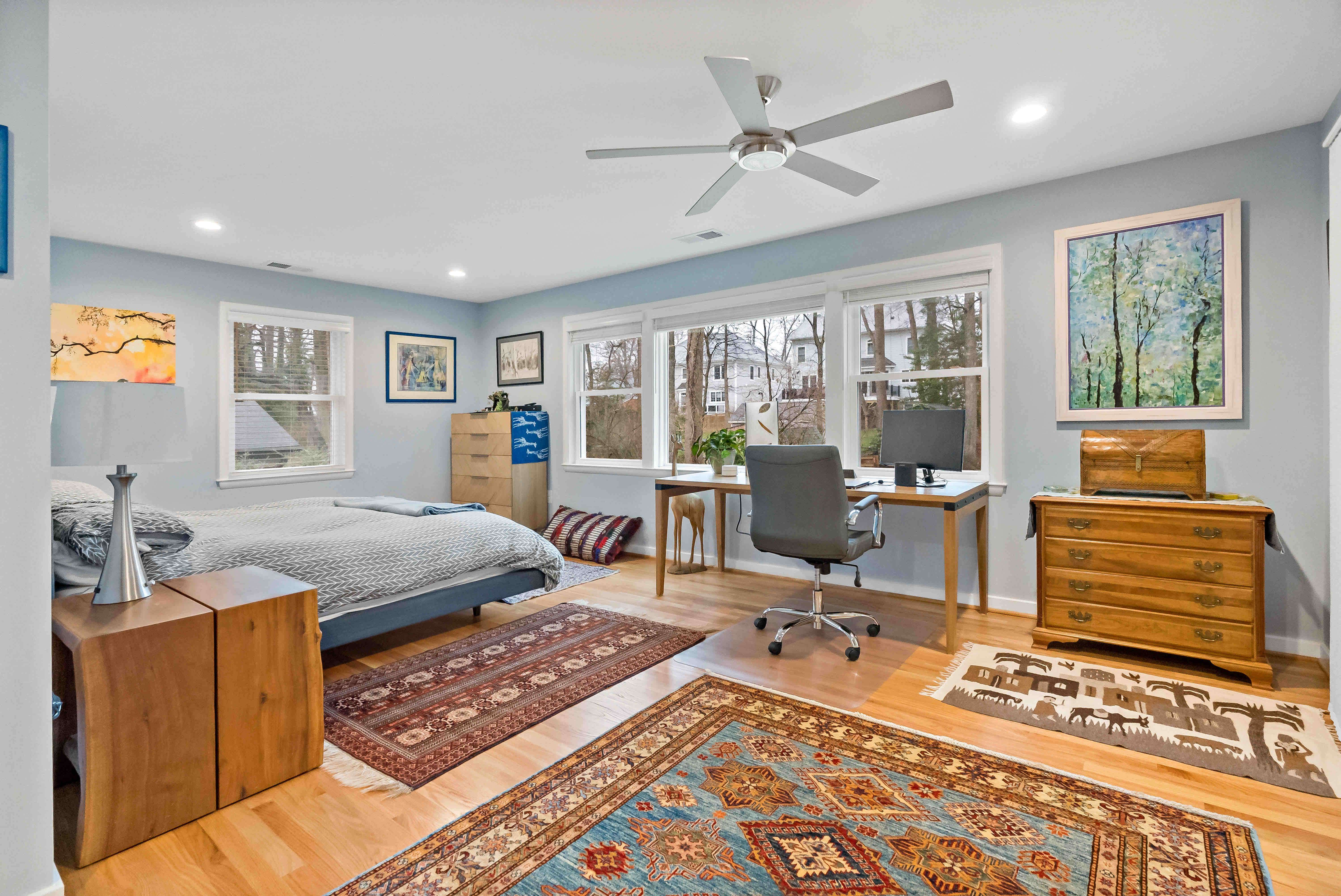 Large bedroom with hardwood floors and wooden furniture