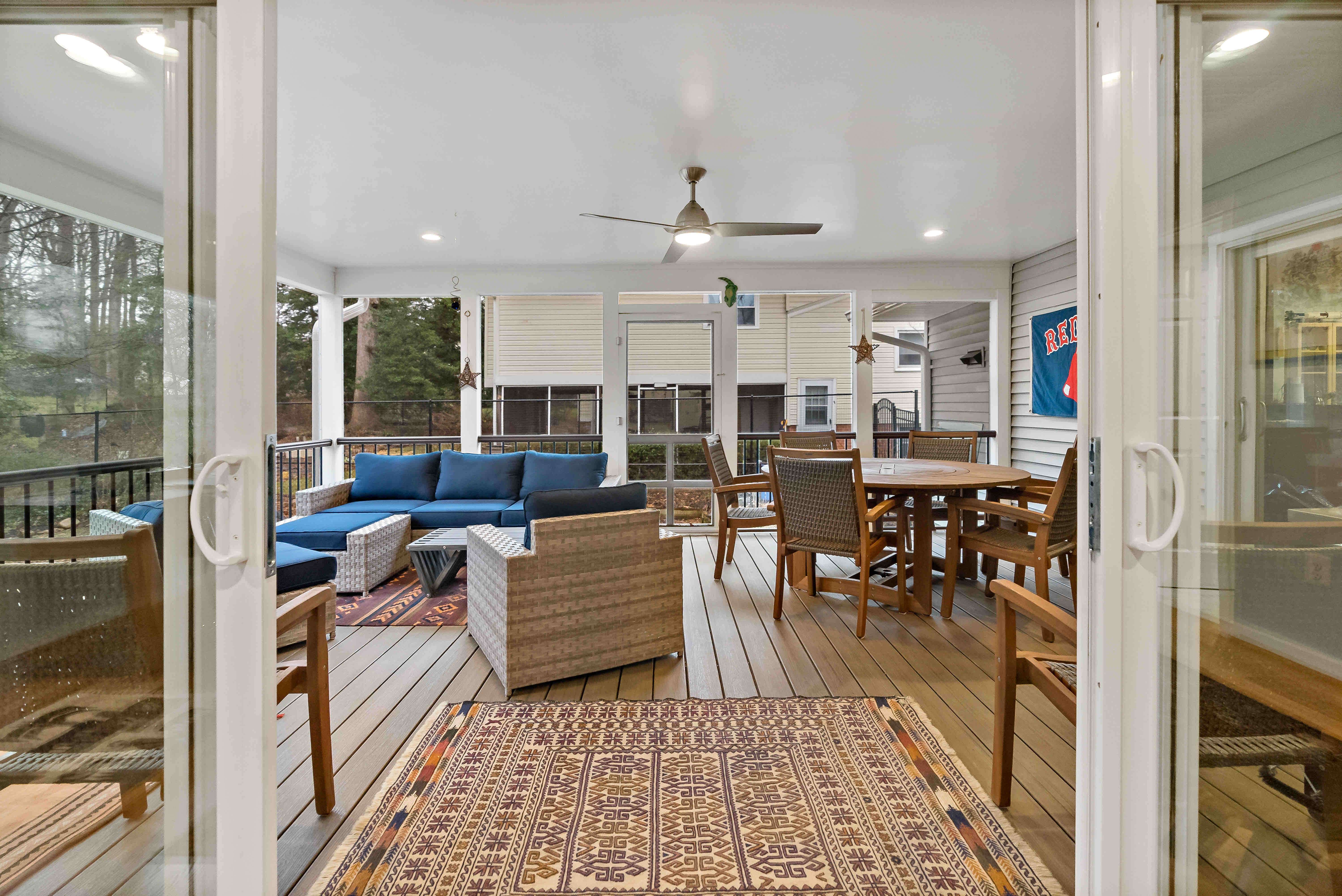 Screened porch with lots of seating on patio furniture