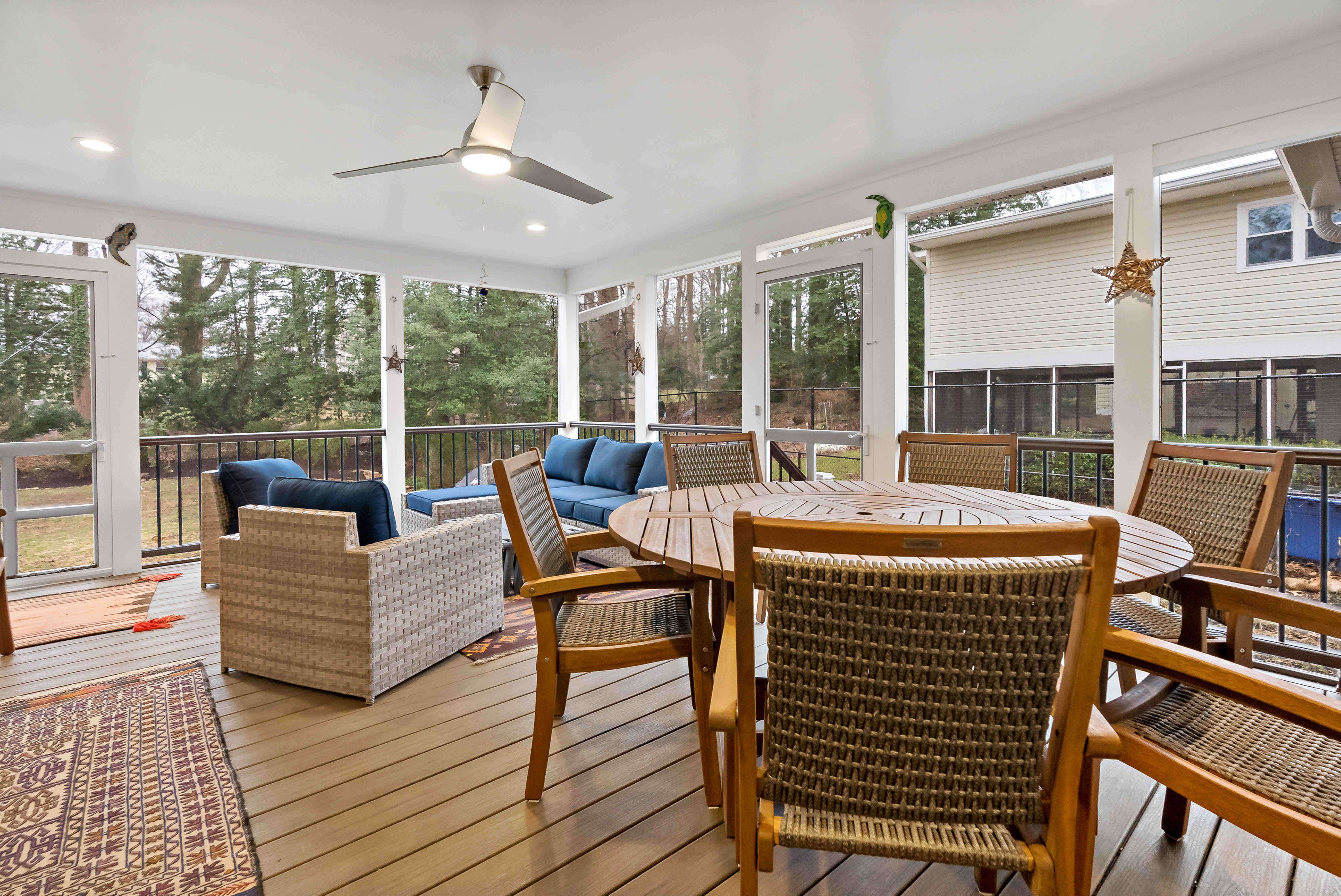 Screened porch with ceiling fan and wood flooring