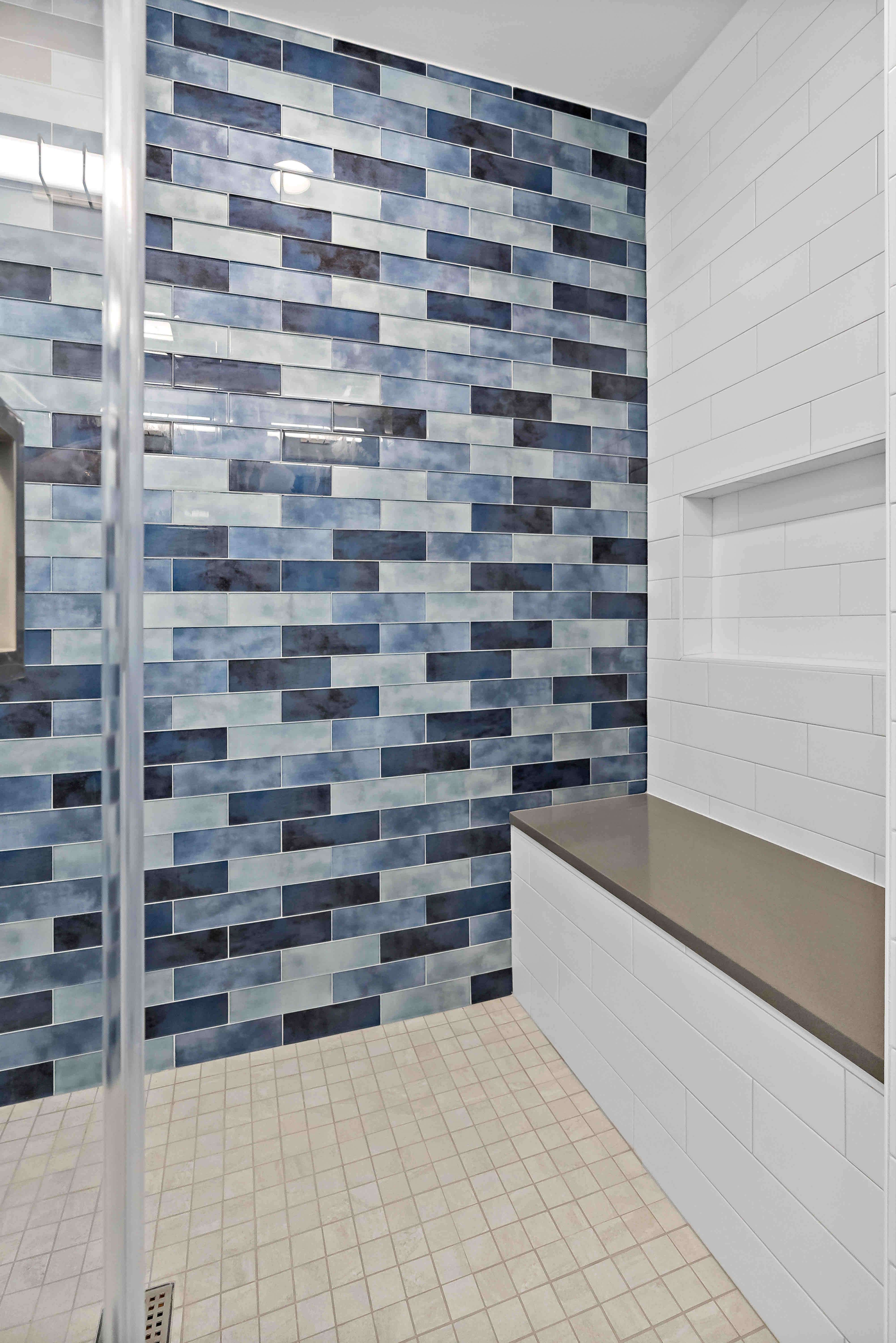 Shades of blue shower tile wall with bench