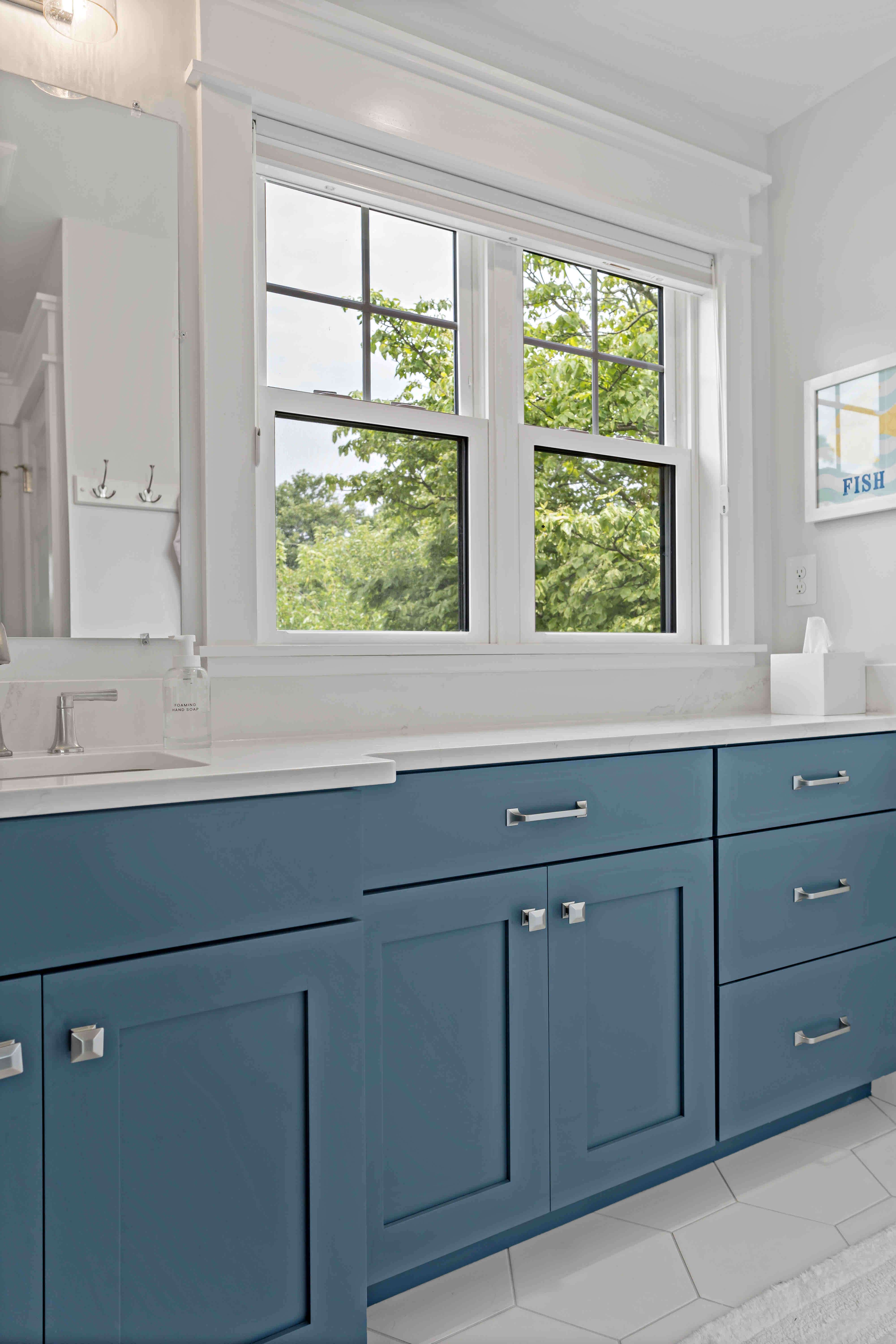 White bathroom with blue cabinetry