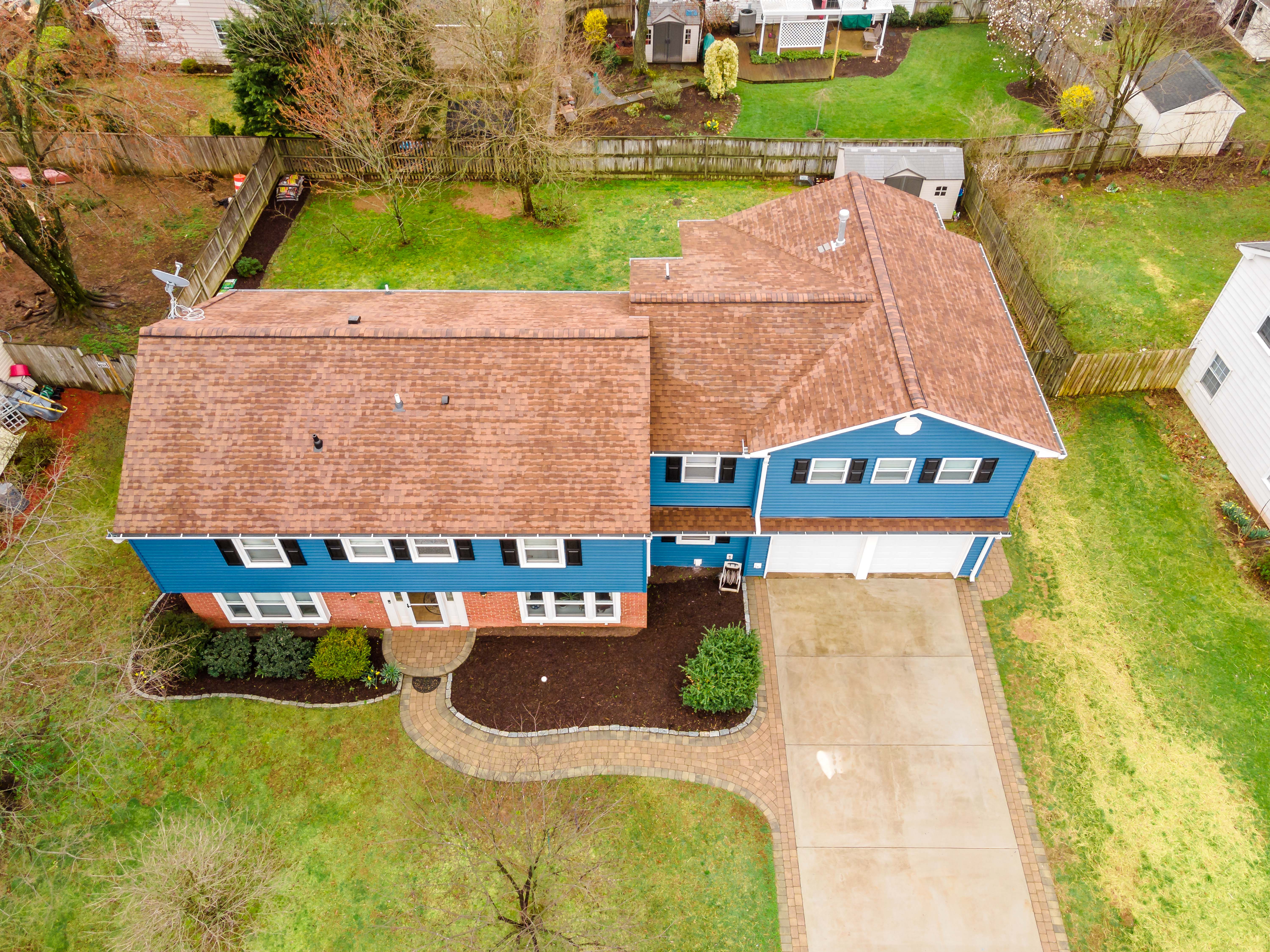 Overhead drone view top of blue home