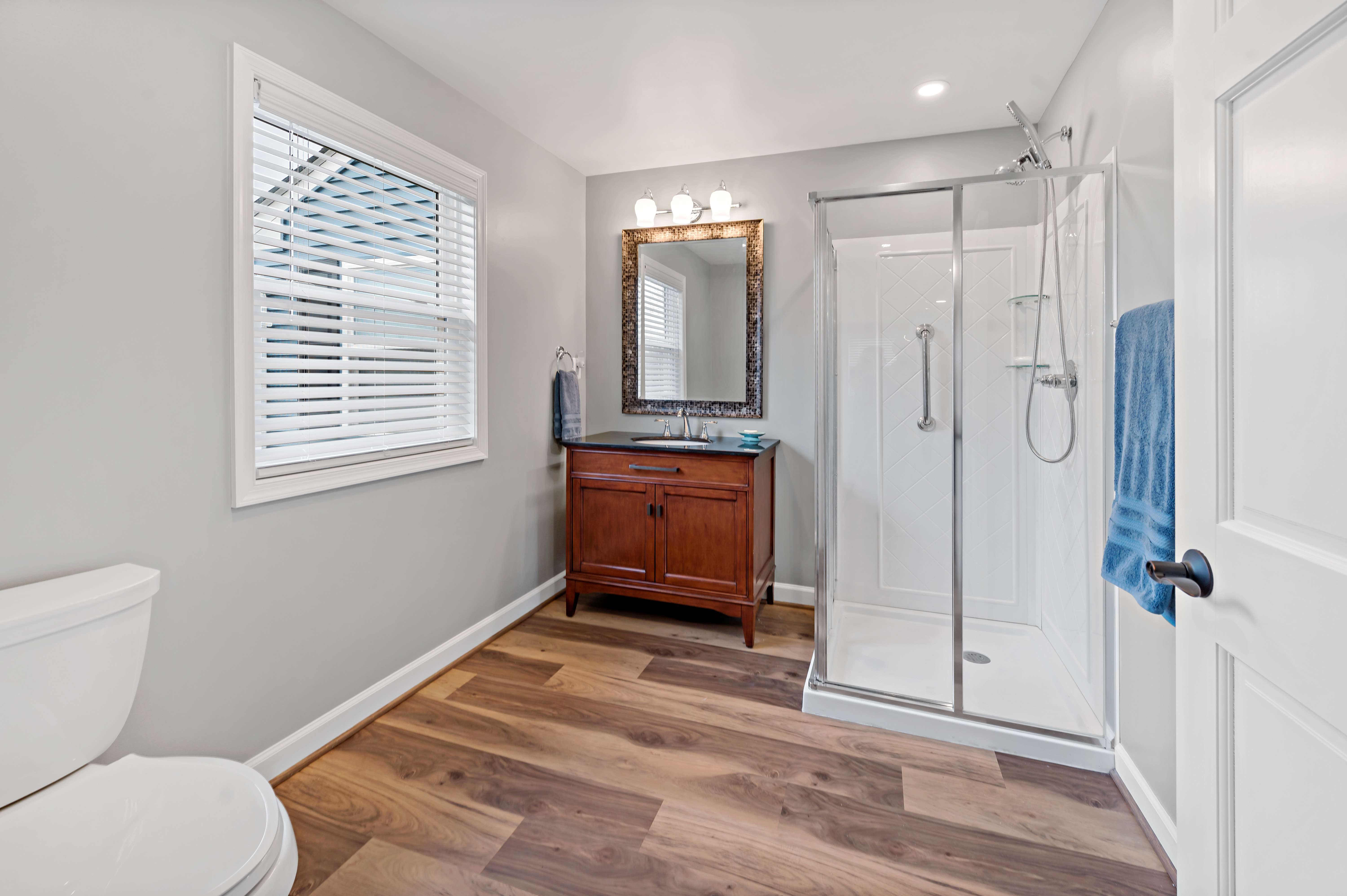 Small full bathroom with brown cabinets