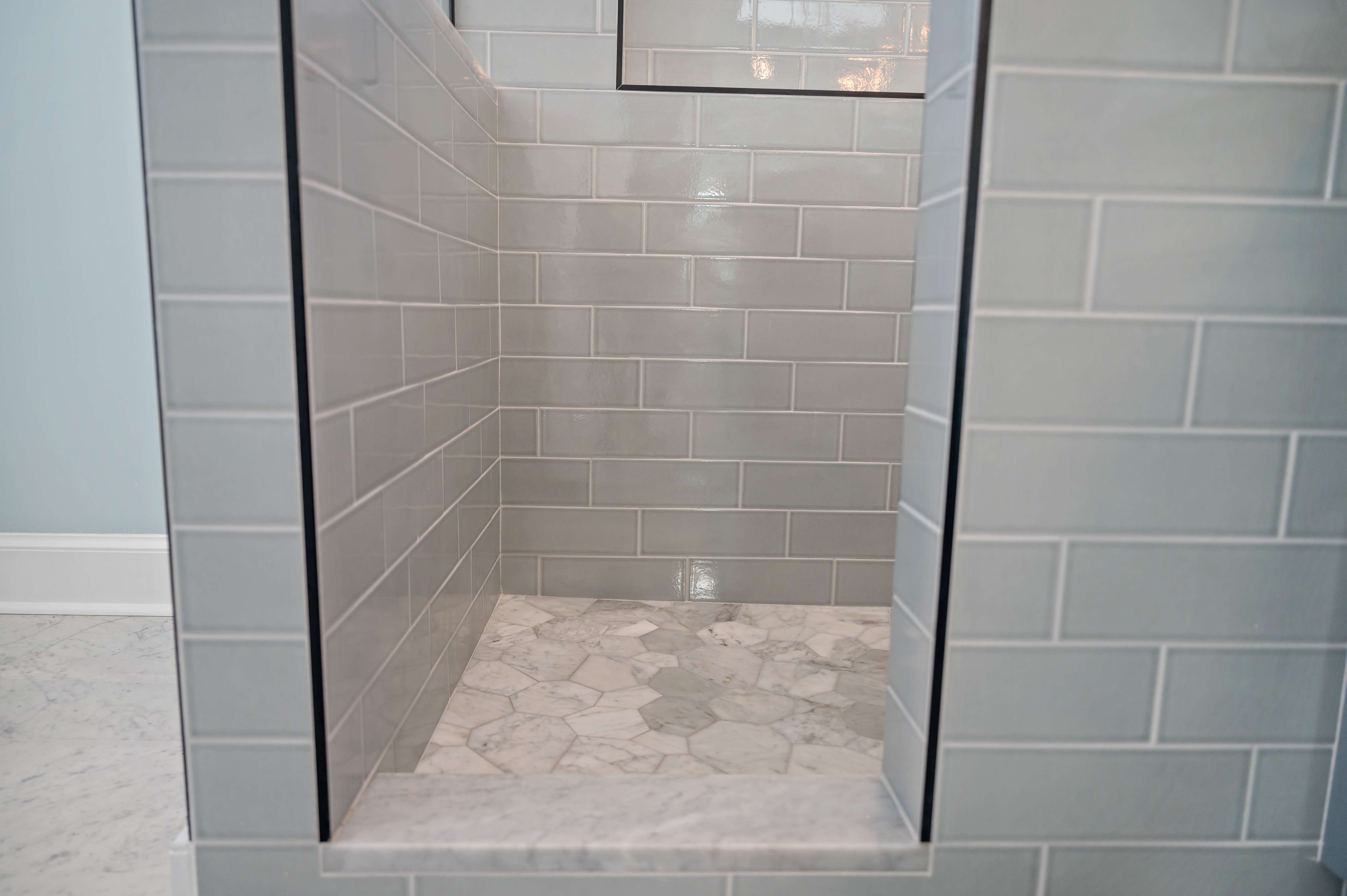 Grey brick tile in shower with step to get in