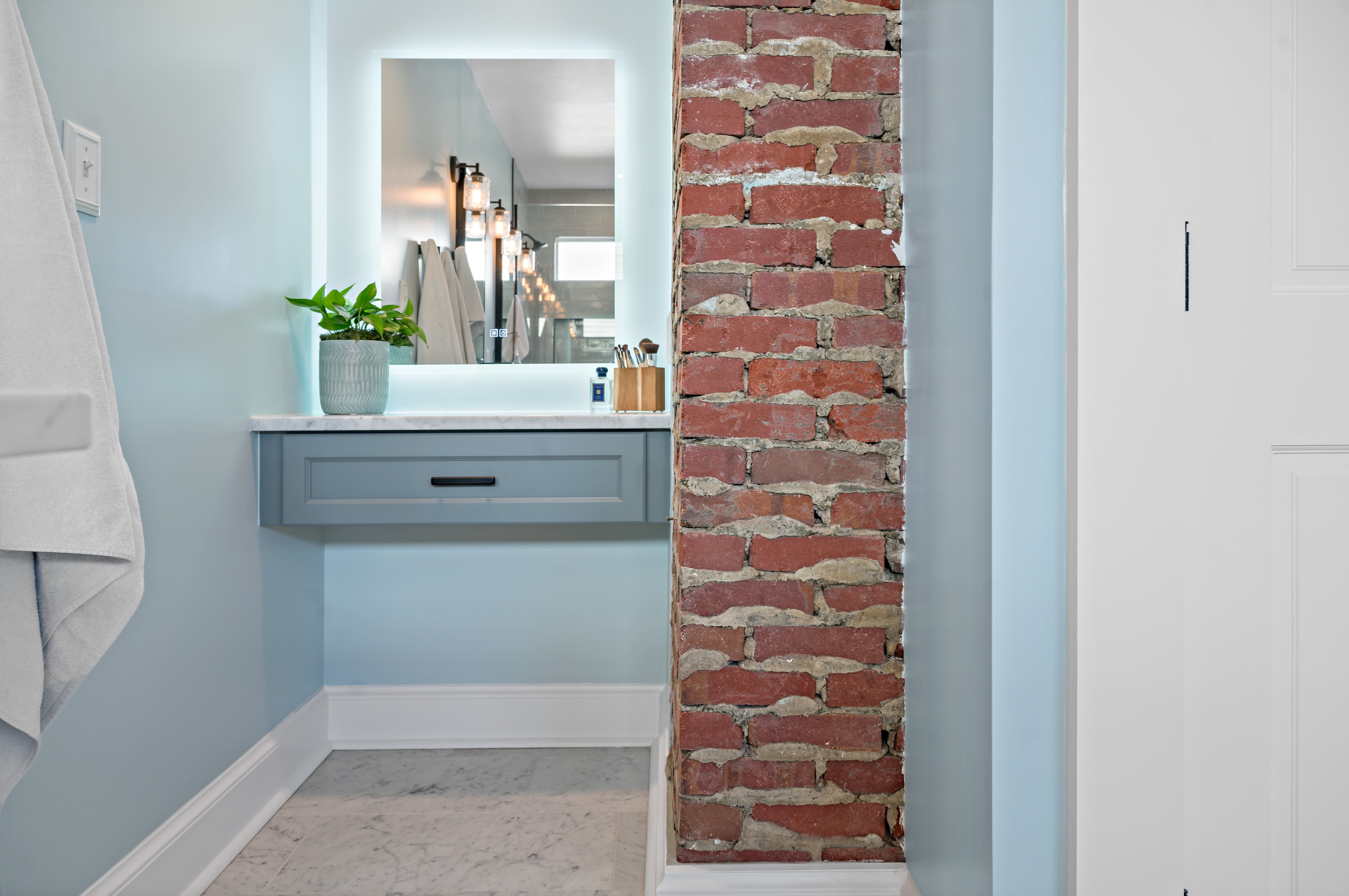 Exposed brick accent wall in bathroom