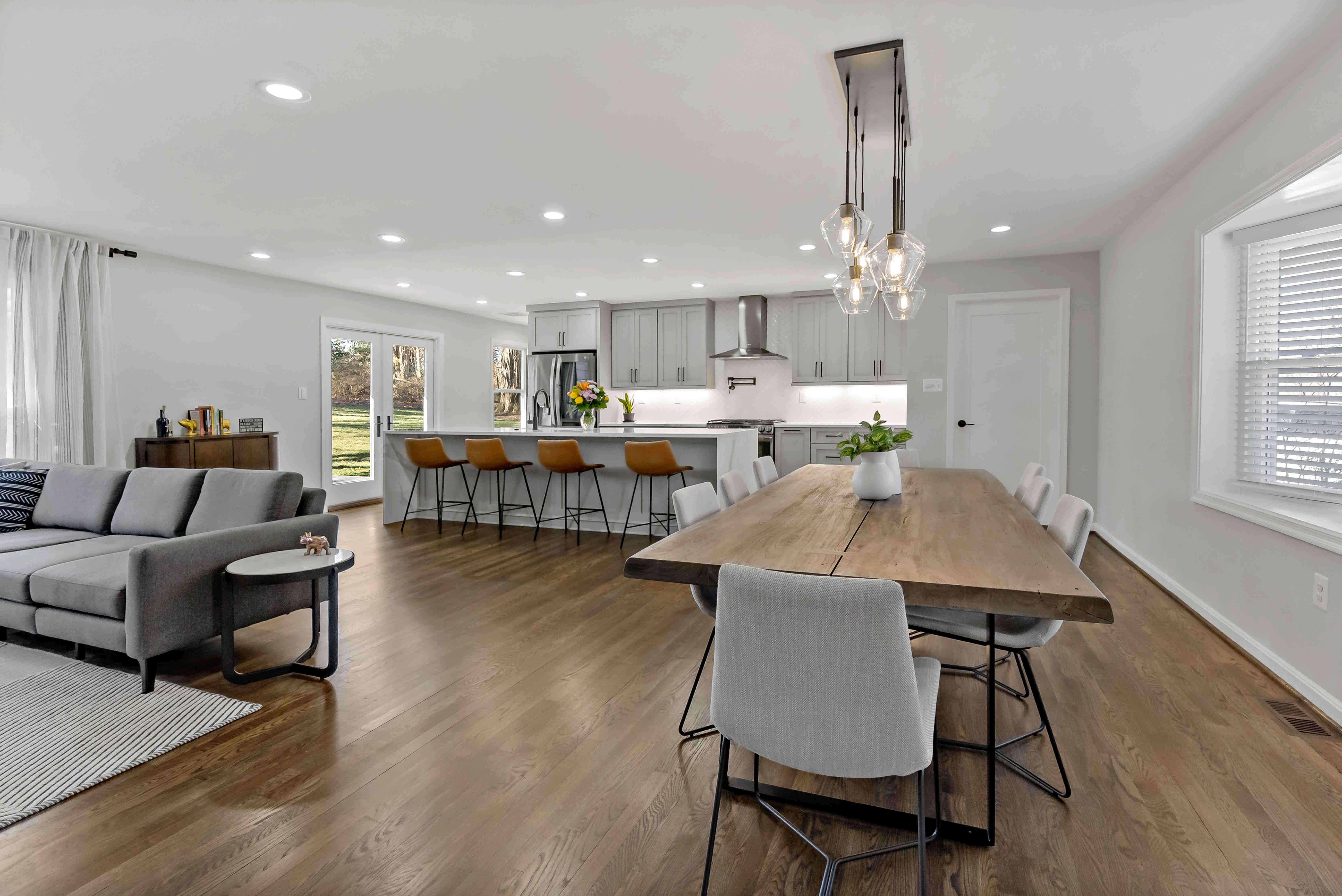 Open concept kitchen space with pendant lighting over dining table