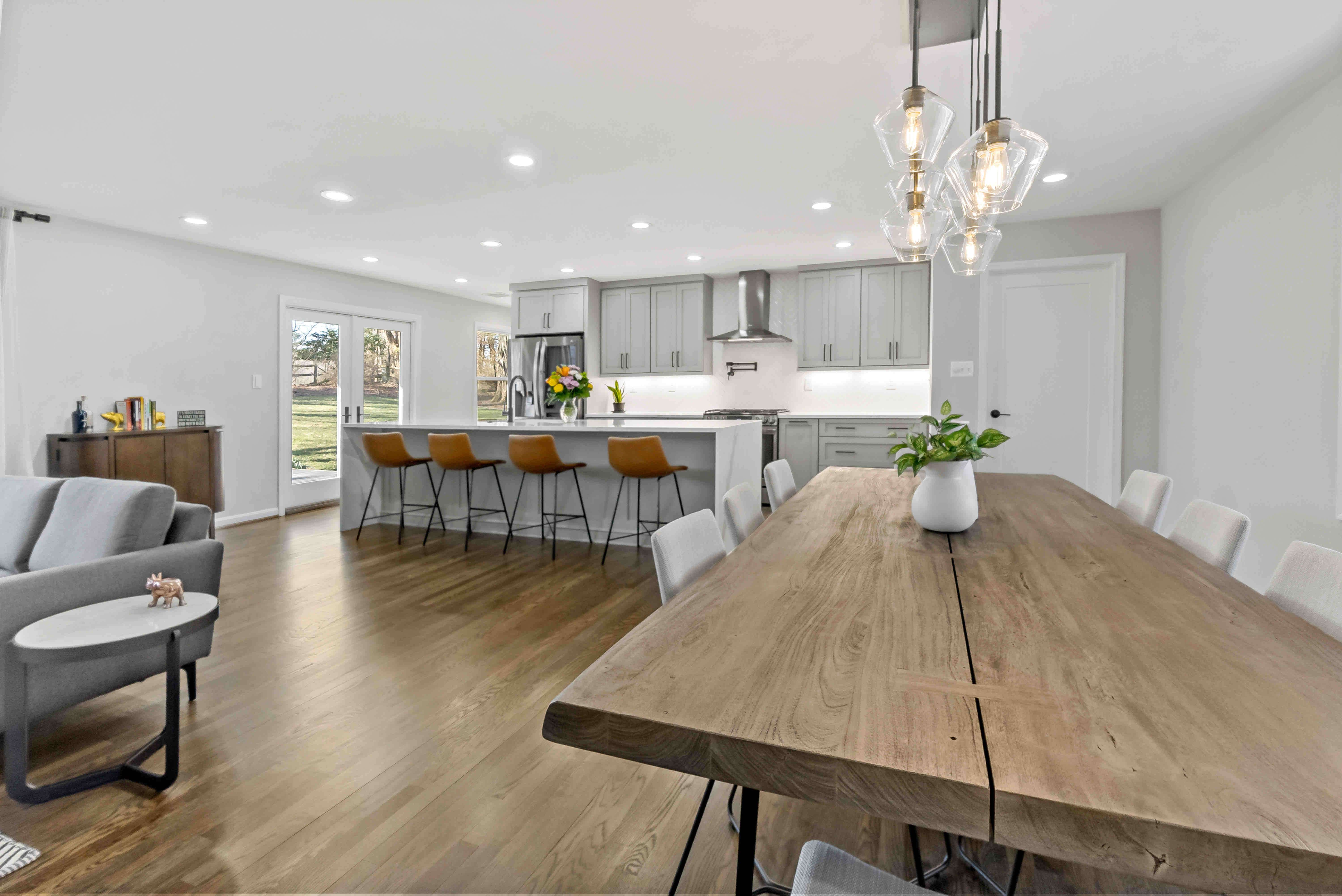 Open concept kitchen space with living room and dining table