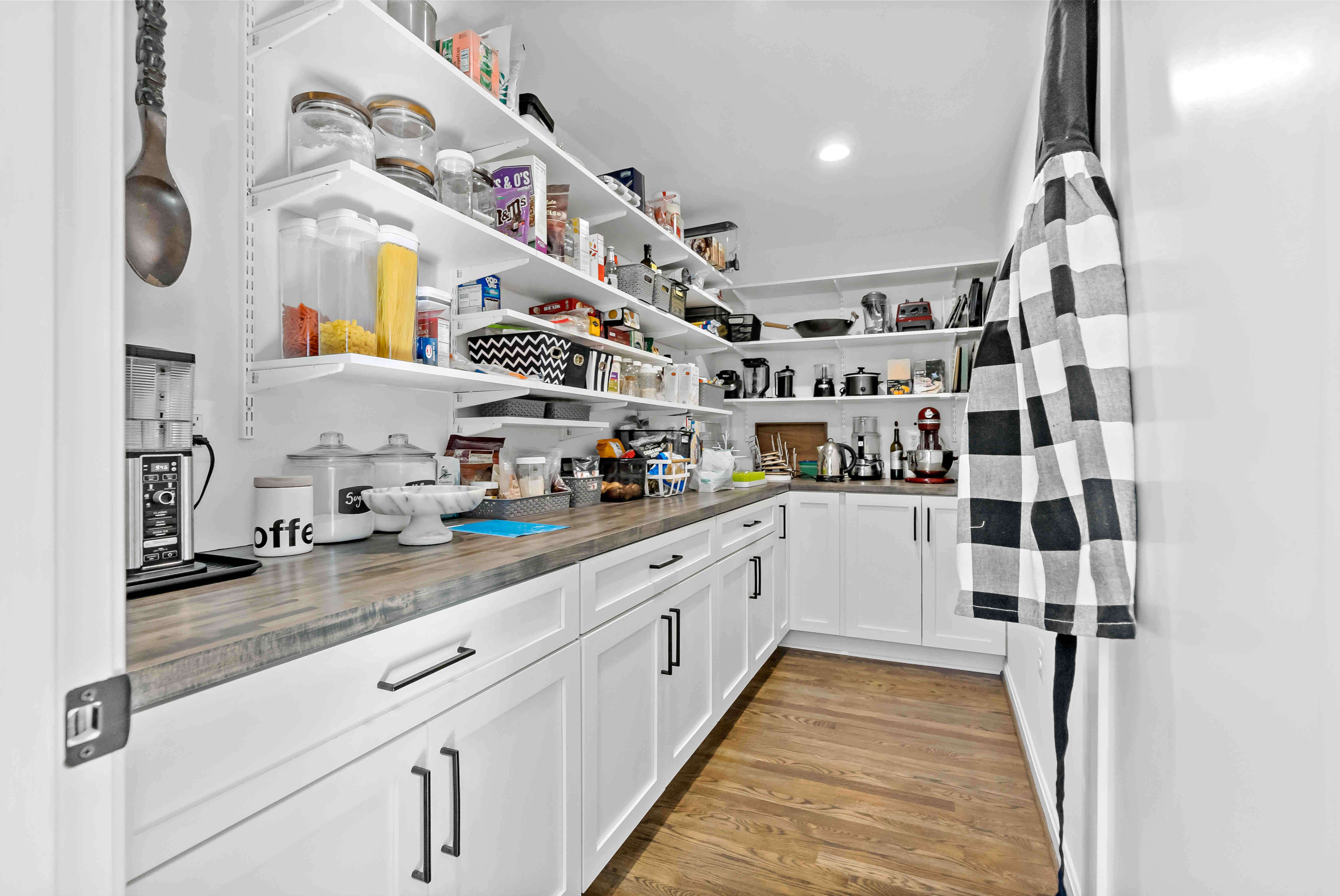 Walk-in kitchen pantry with floating shelves